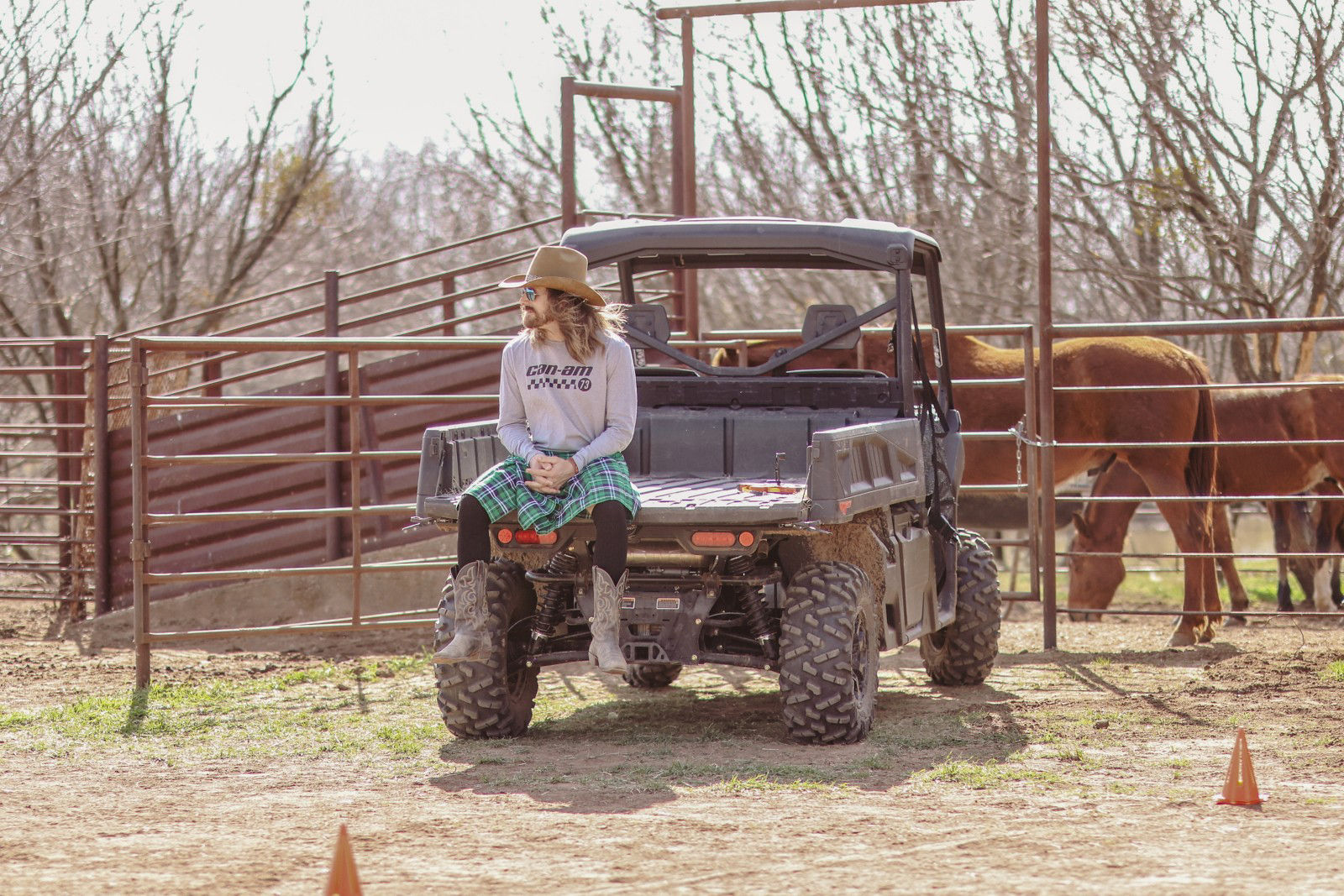 Dale Brisby riding a horse on a farm with a Can-Am SXS