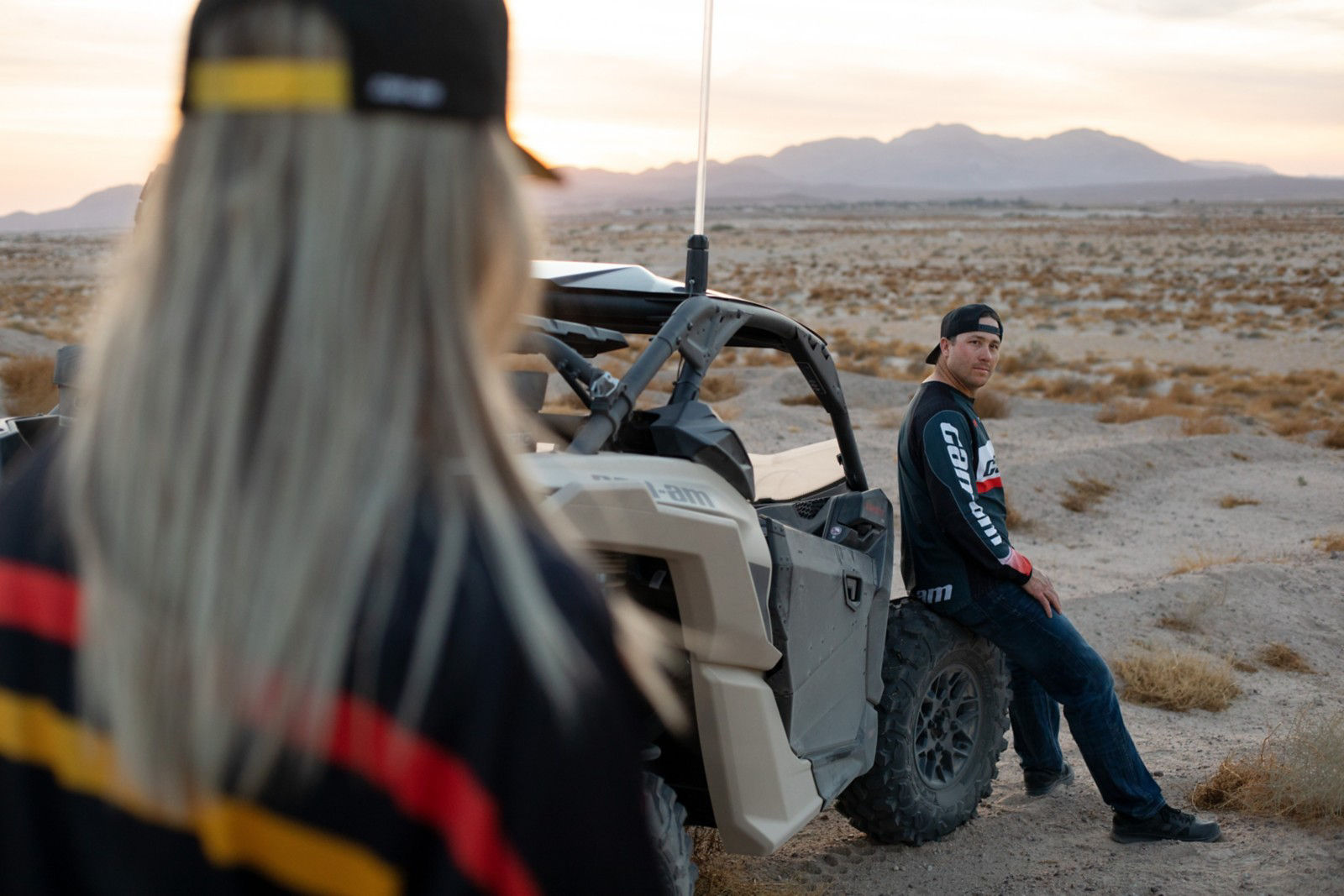 Couple with their Can-Am vehicle after a day of riding