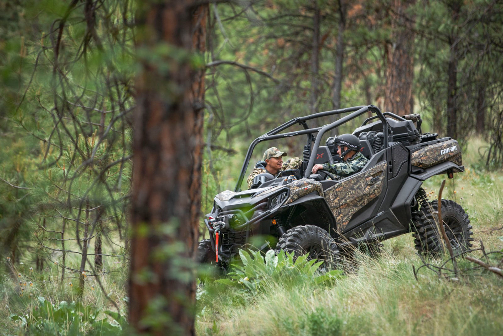 SxS with rider on dirt trail in woods
