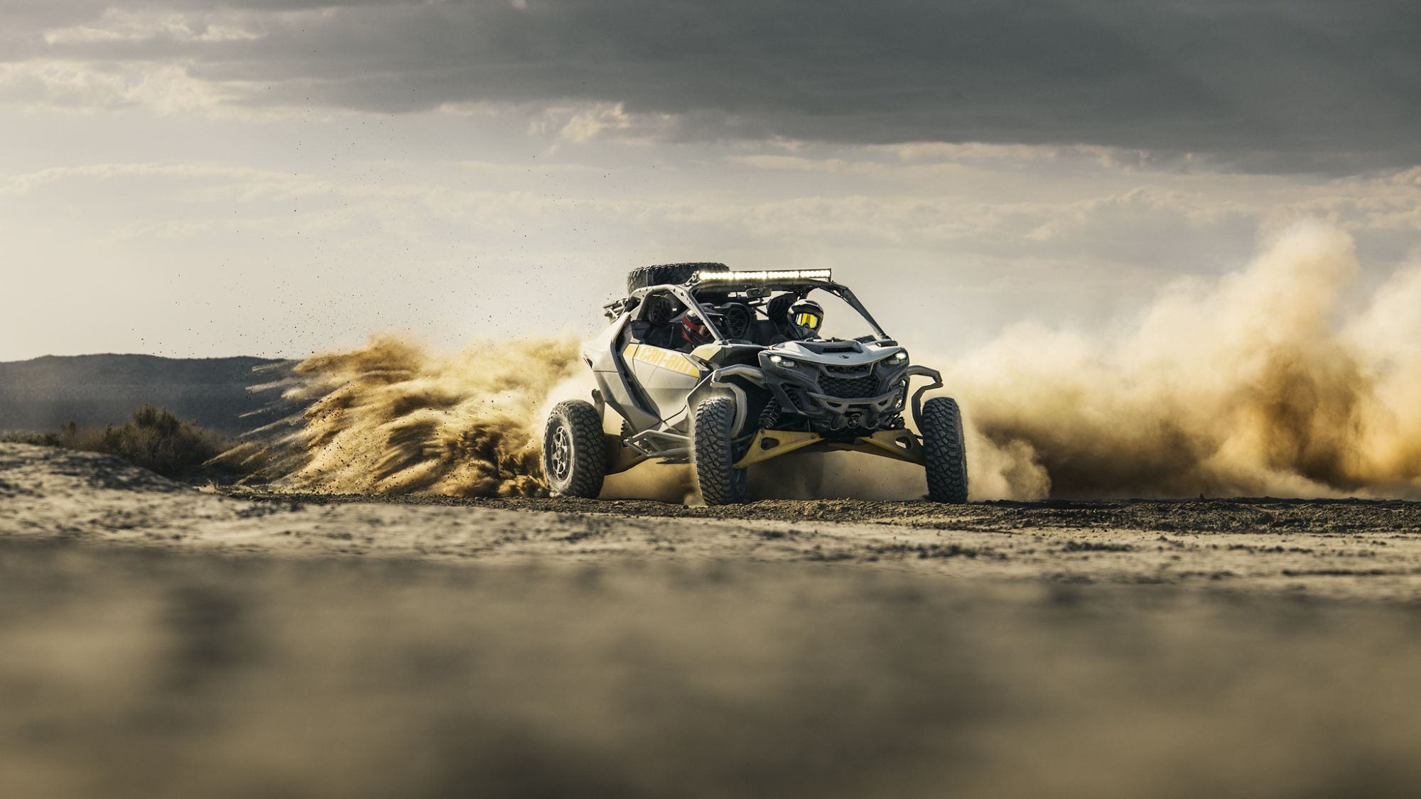A Can-Am Maverick R 2024 with 7-speed dual-clutch transmission speeding through the desert.