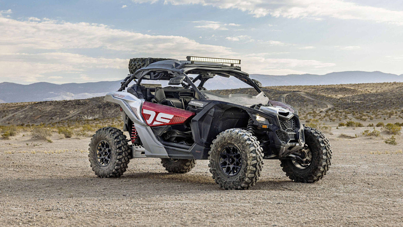 2024 Can-Am Maverick X3 parked in the middle of a dirt field