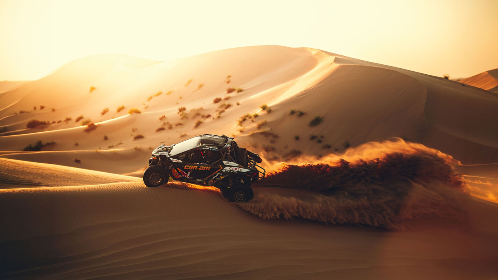 A Can-Am side-by-side racing across the dunes of the Dakar Rally