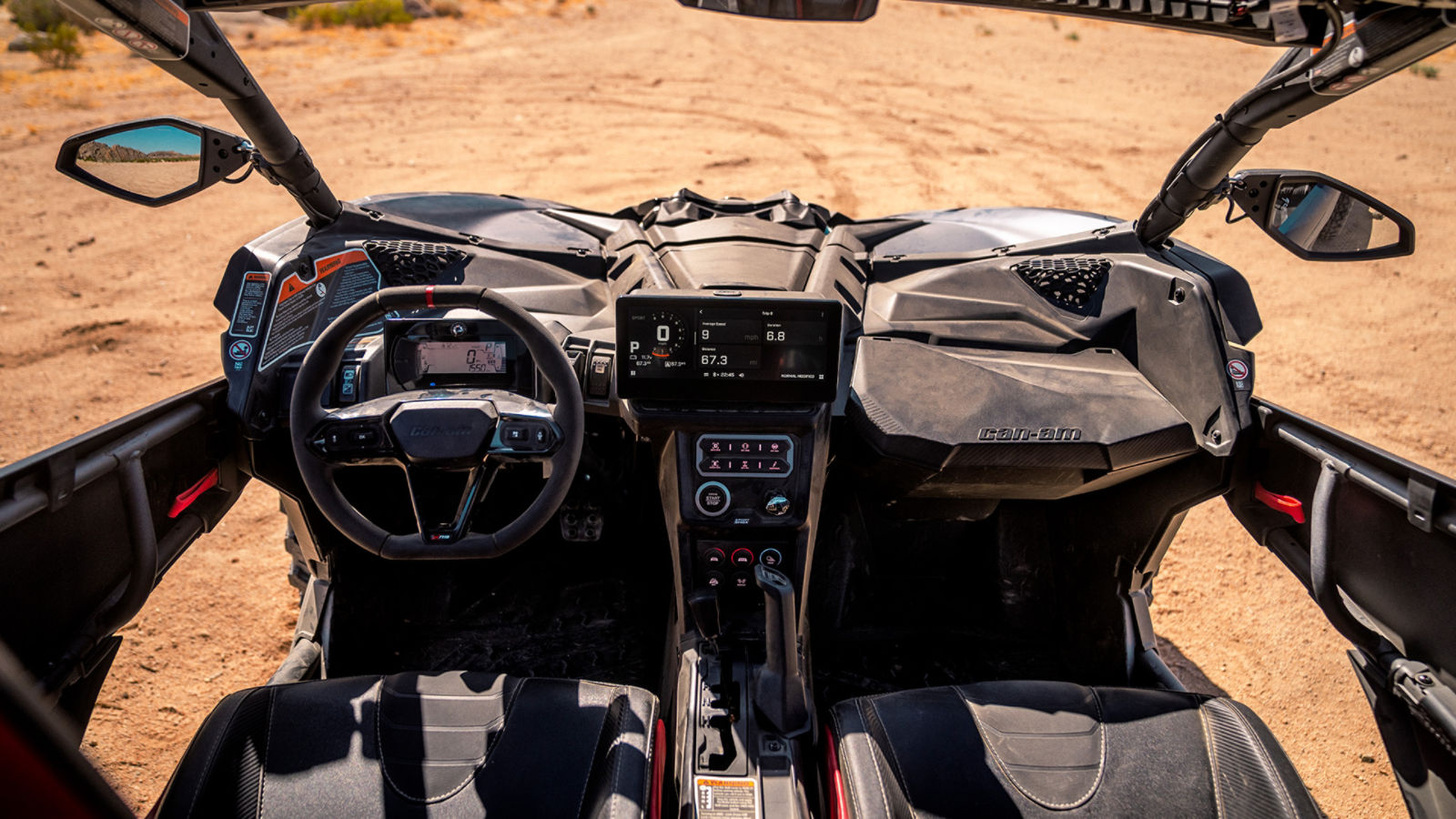 Interior and digital display of a Can-Am side-by-side vehicle parked in the desert