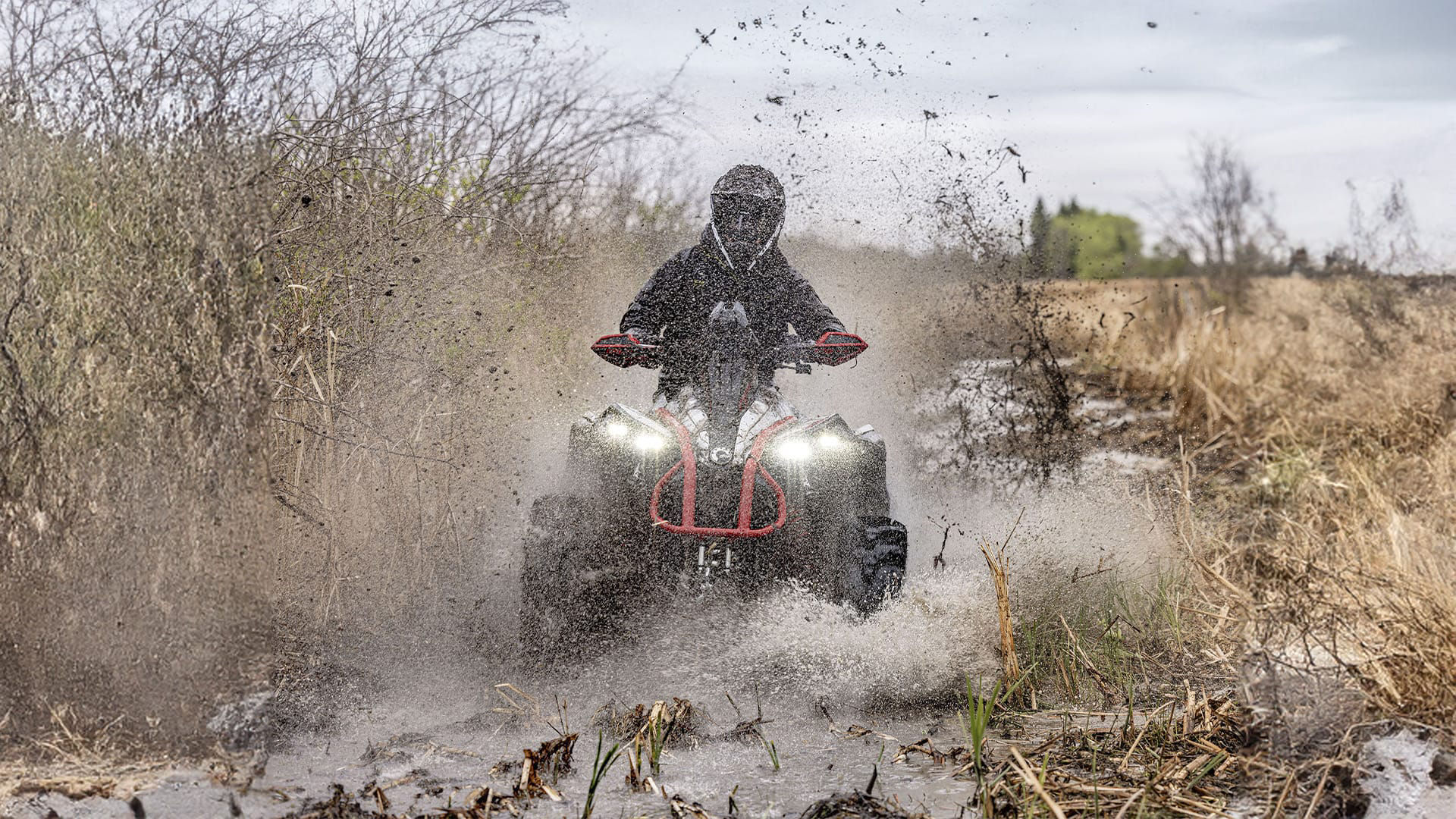 Can-Am Renegade passing through a mud puddle