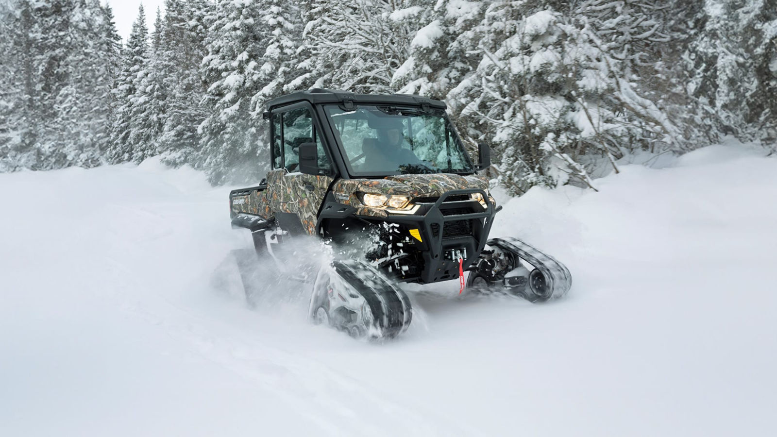 Can-Am Defender equipped with winter track system riding over snow