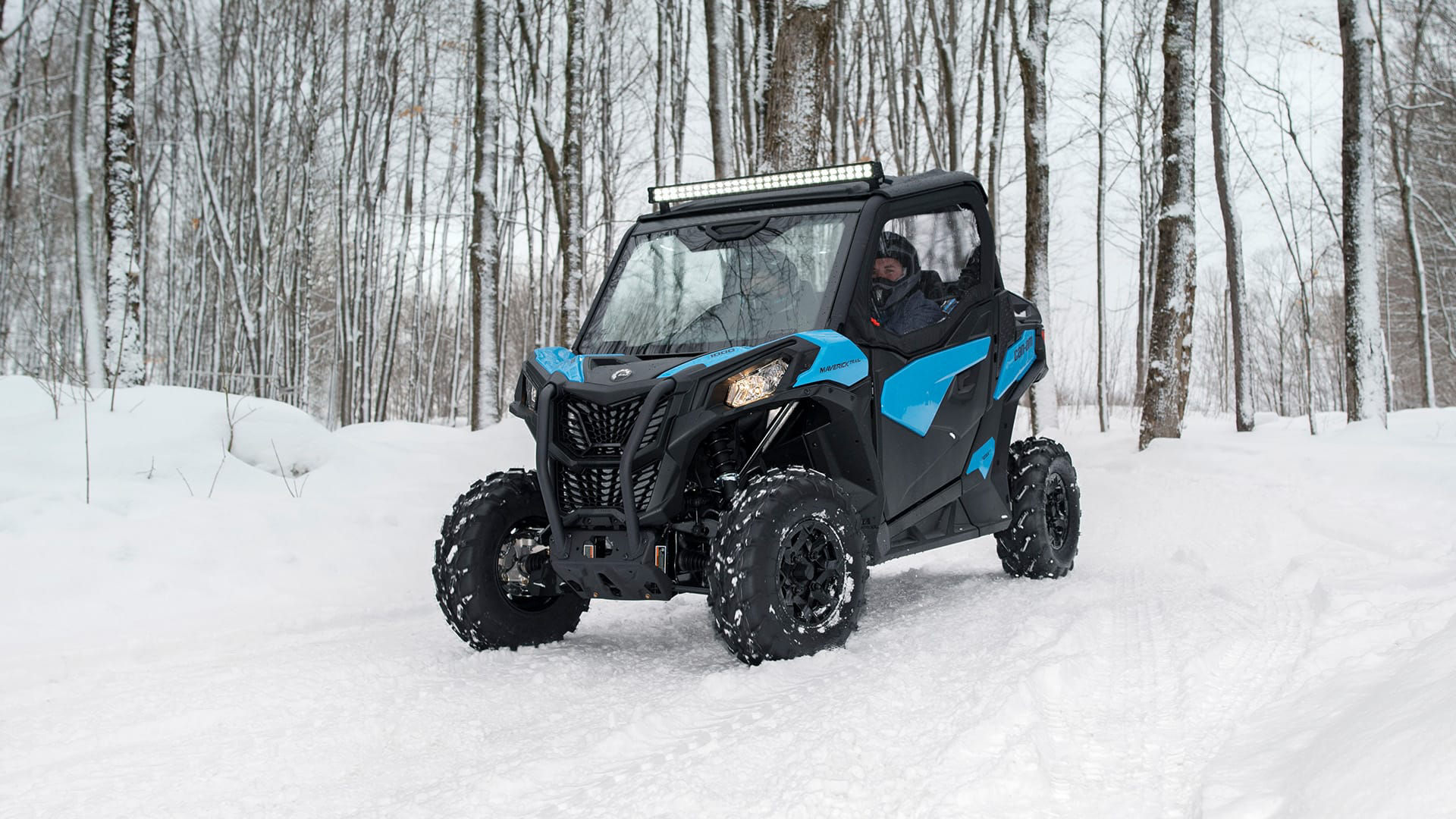 Can-Am Maverick Trail going over snow in the woods