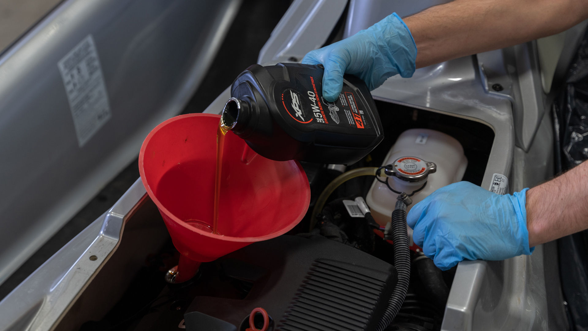 Person washing a Sea-Doo Wake with XPS products