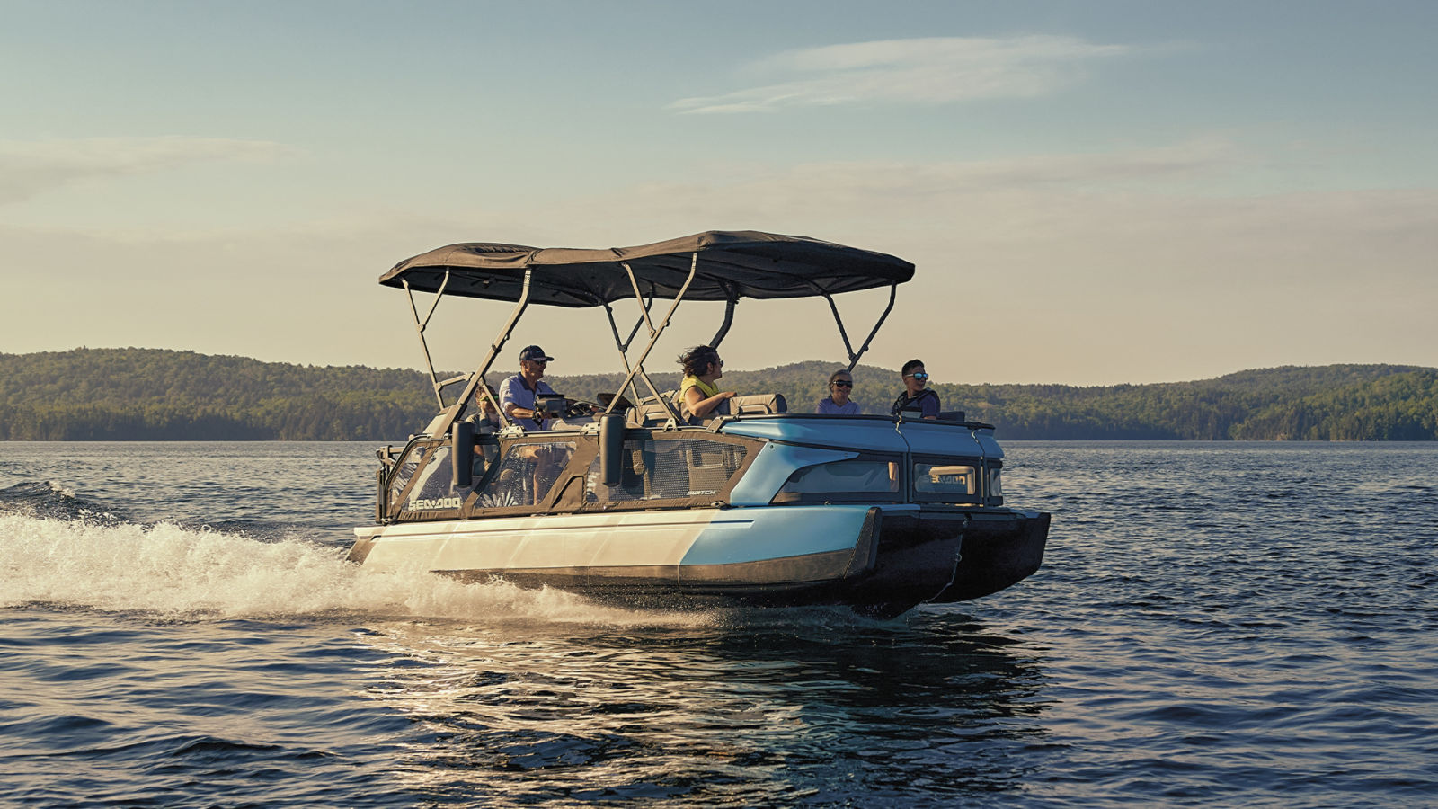 Family taking a ride on a Sea-Doo Switch pontoon boat
