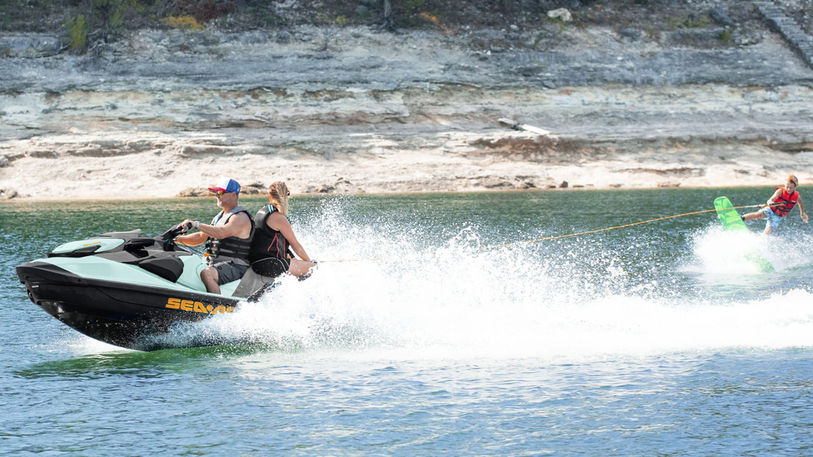 Couple on a Sea-Doo Wake pulling a wakeboarder