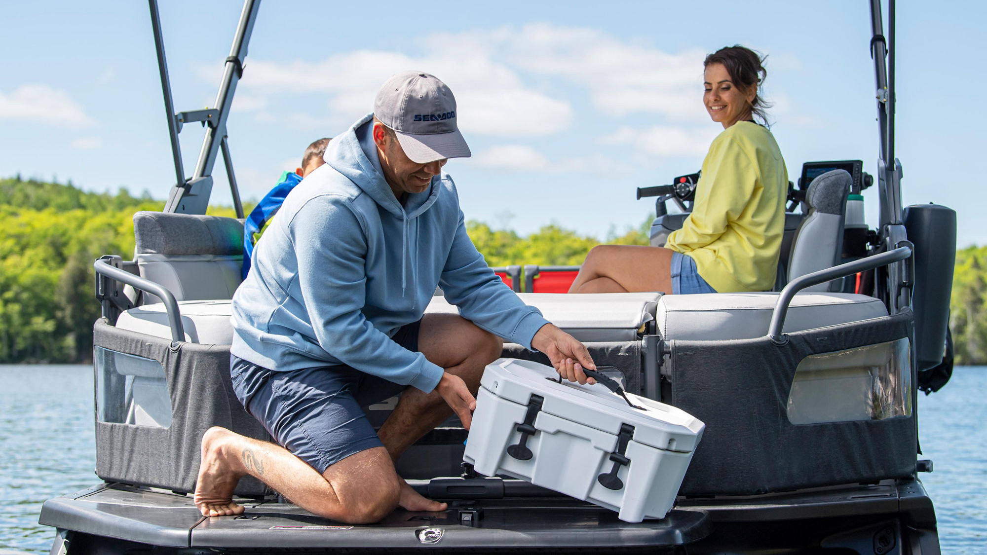 Men attaching a LinQ cooler on a Sea-Doo Switch pontoon