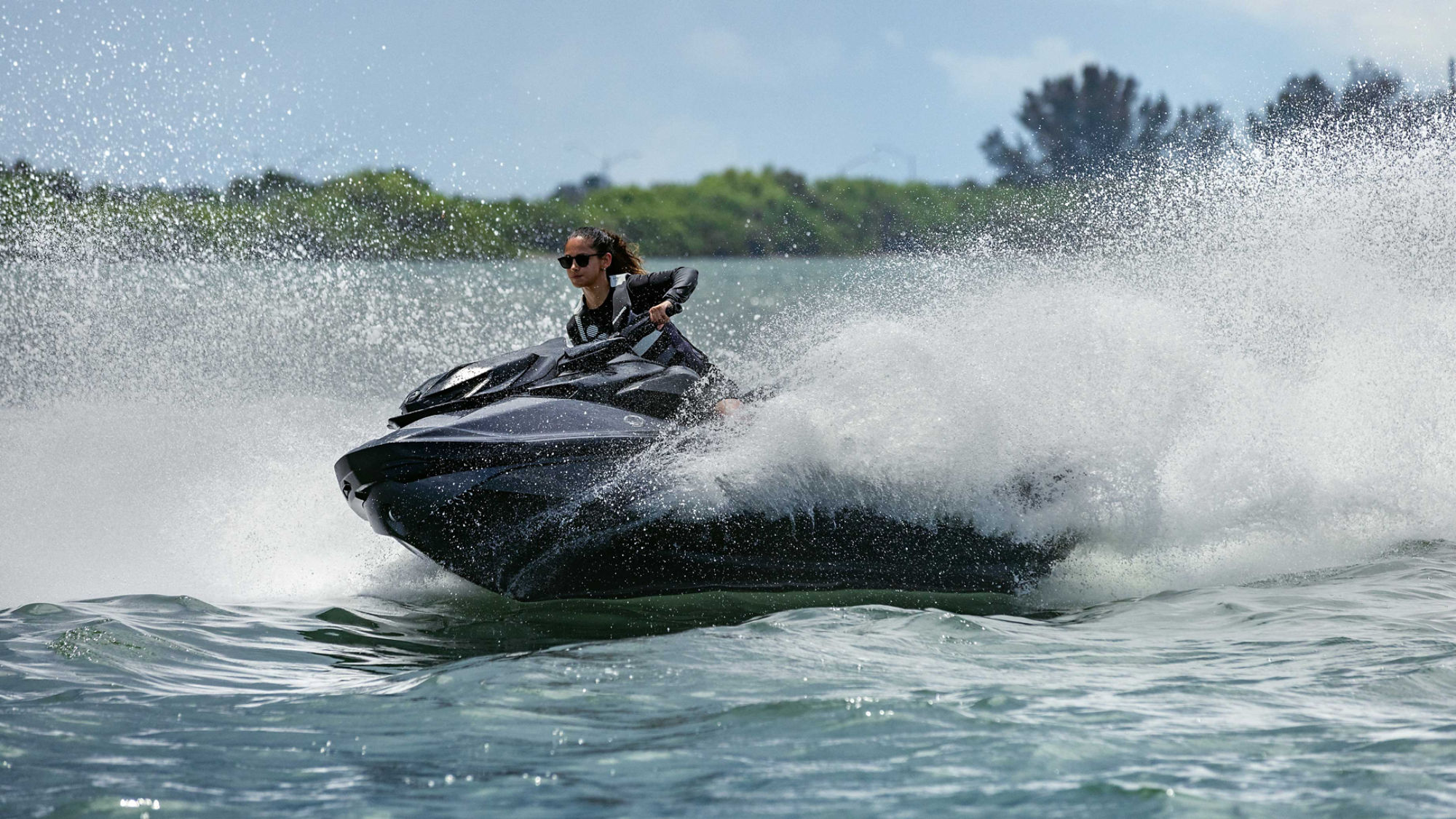Women riding a Sea-Doo RXT-X personal watercraft