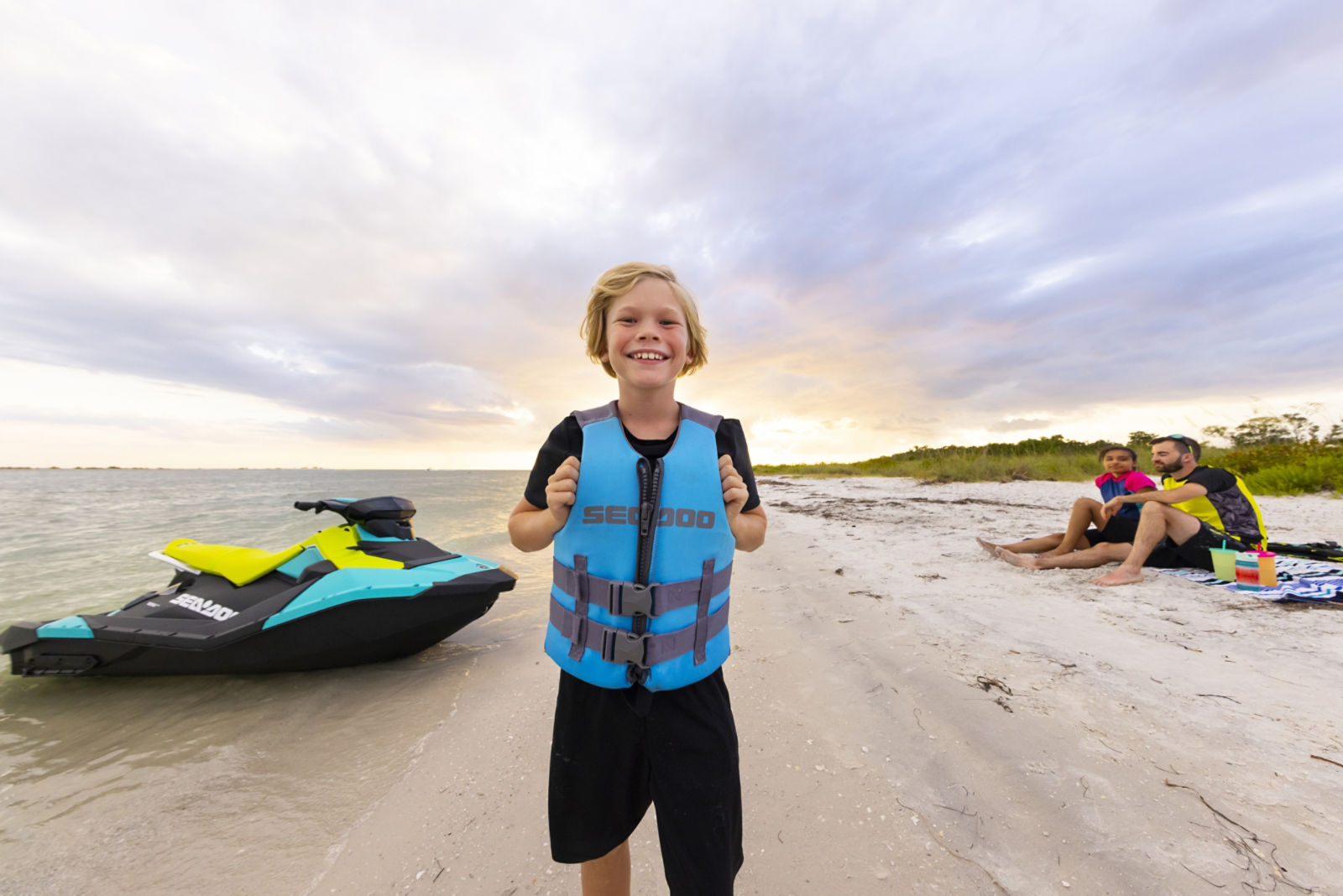 Kid with a Sea-Doo lifevest smiling