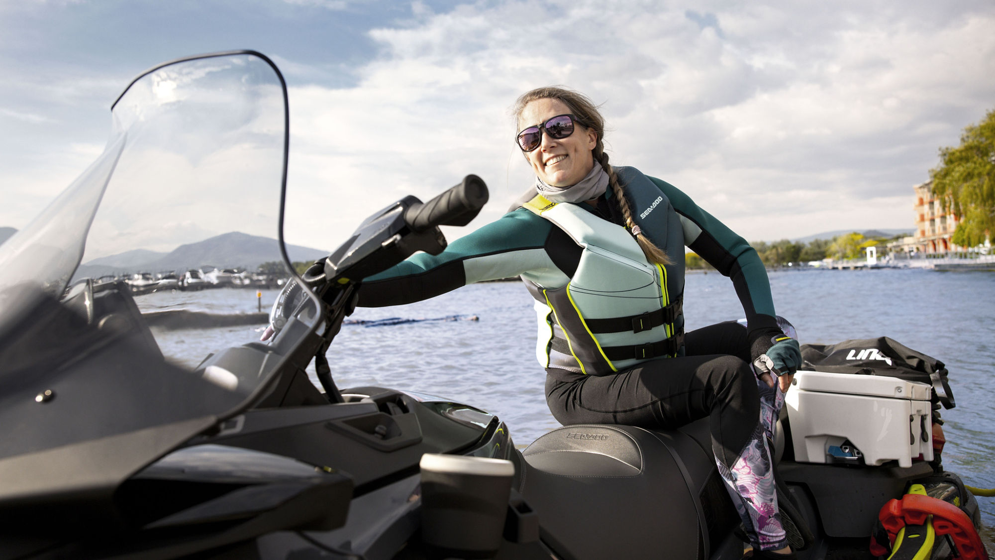Women reaching for the handlebar of her 2024 Sea-Doo Explorer Pro
