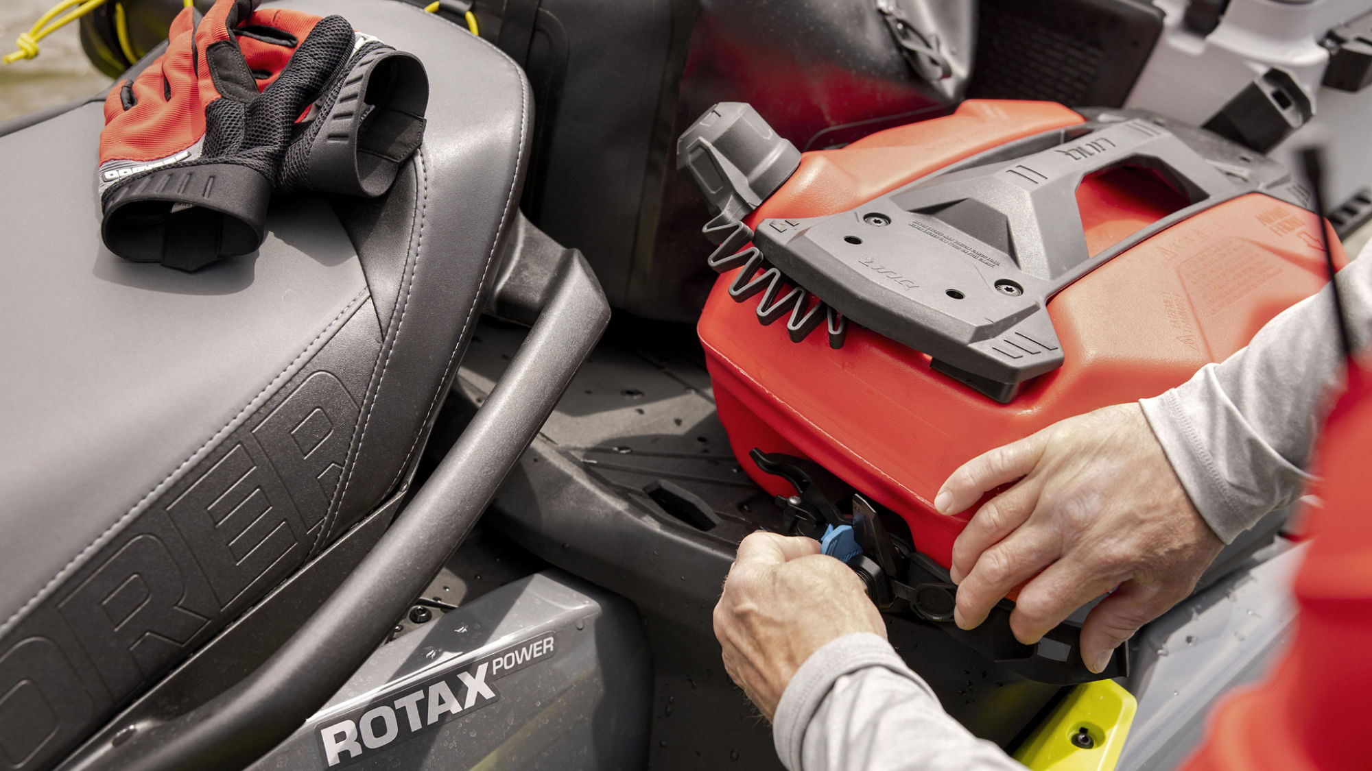 Person attaching a LinQ fuel caddy to a Sea-Doo Explorer Pro