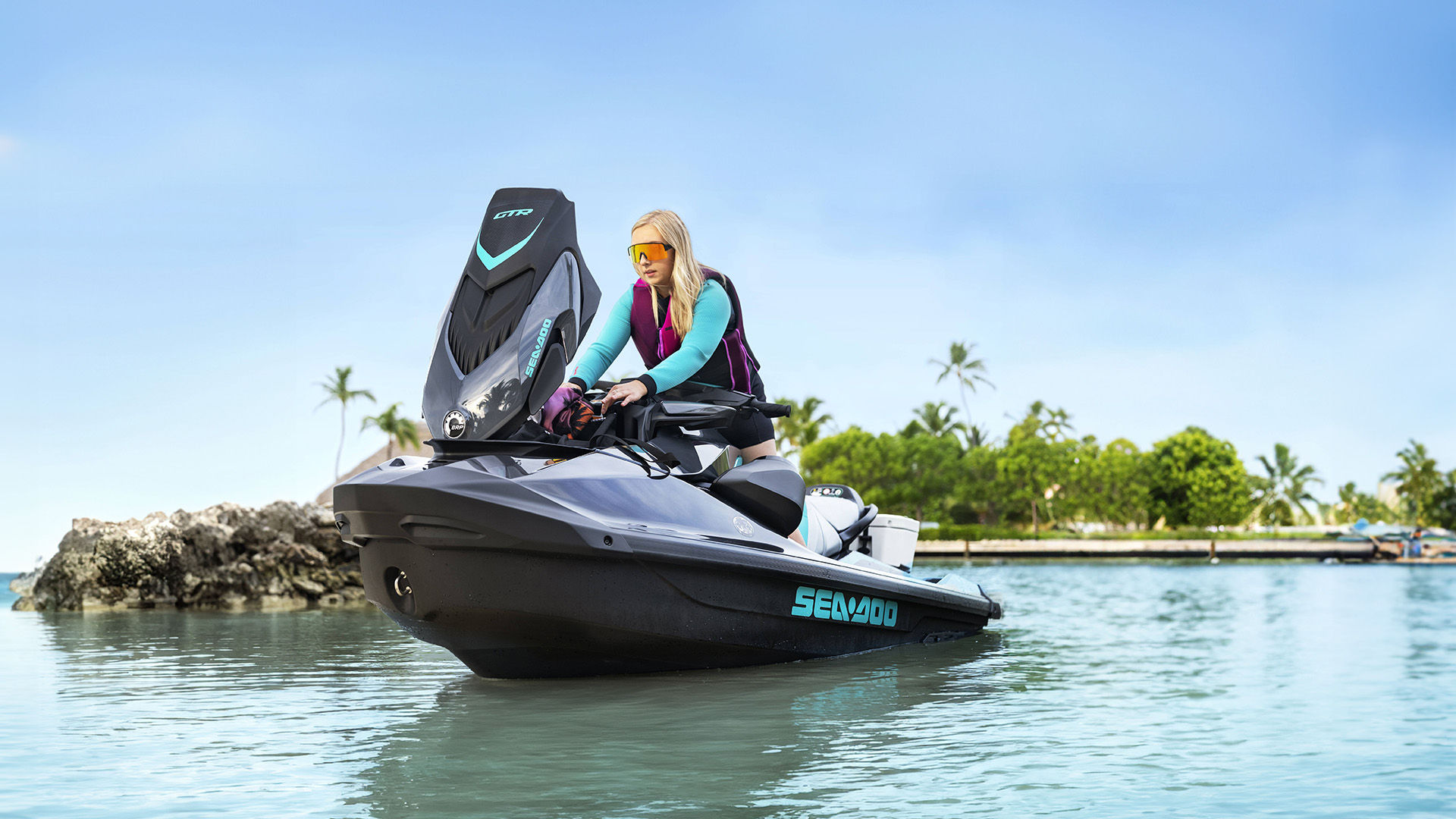 Person reaching for some accessories in a Sea-Doo storage 