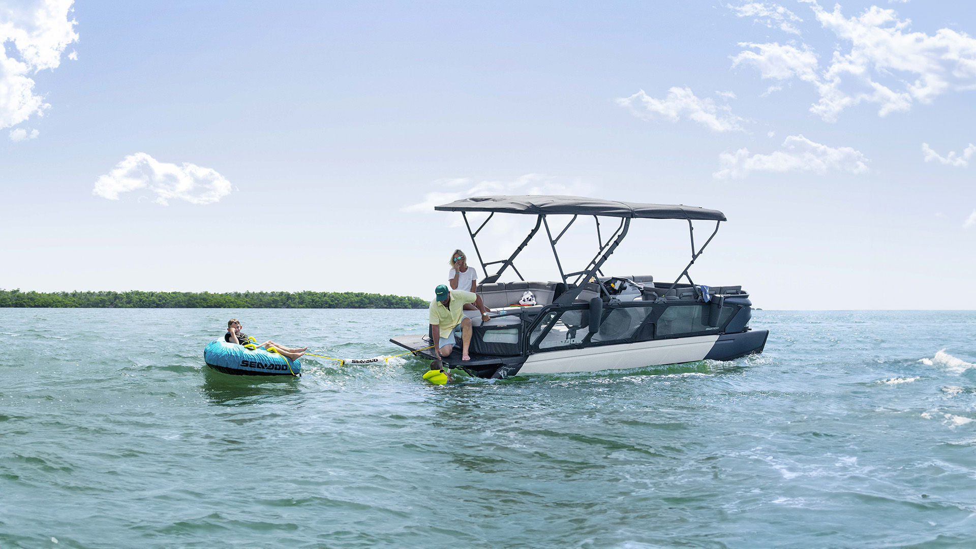 Switch sport towing a person on a Sea-Doo floater