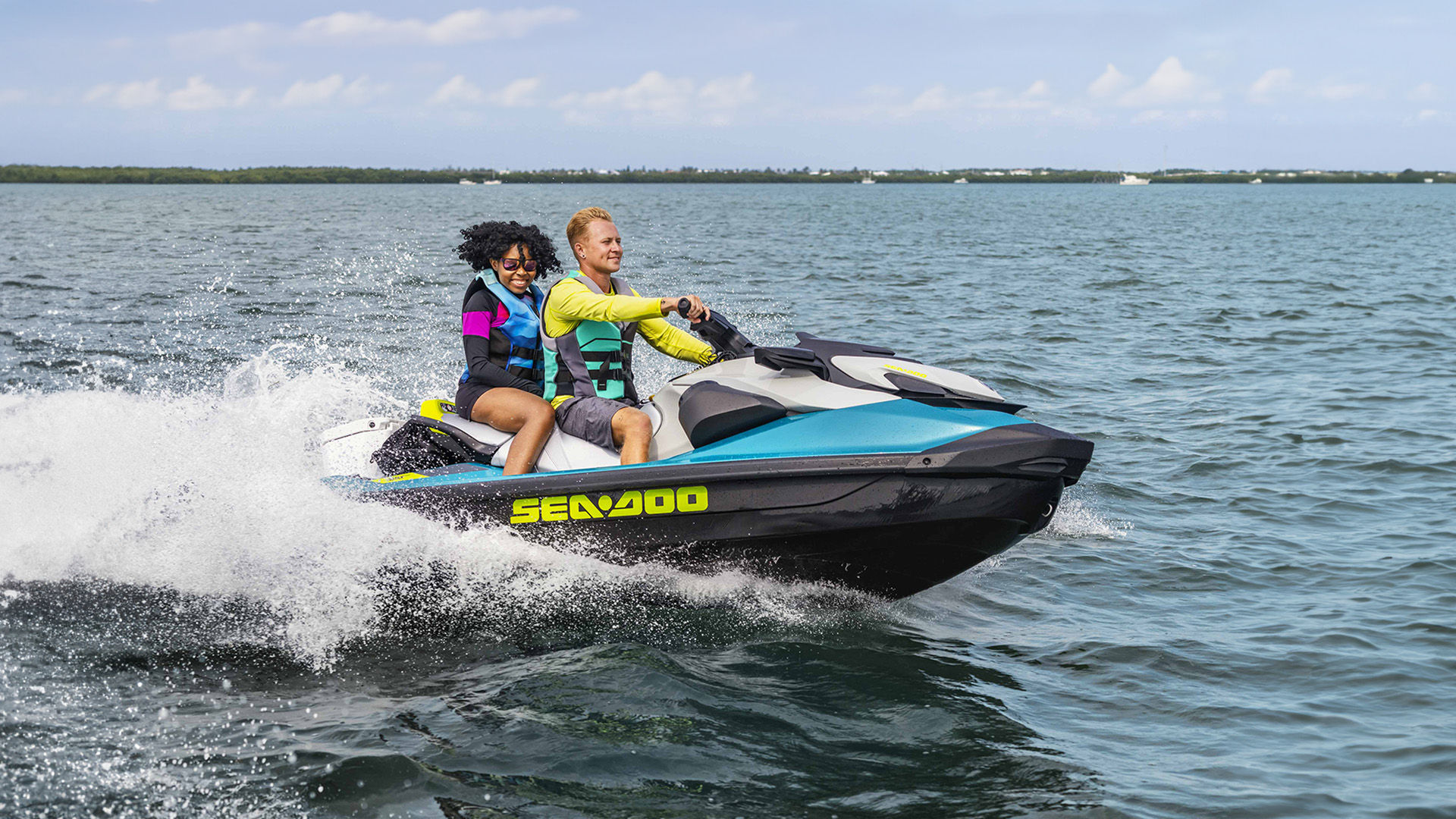 Two women riding a PWC