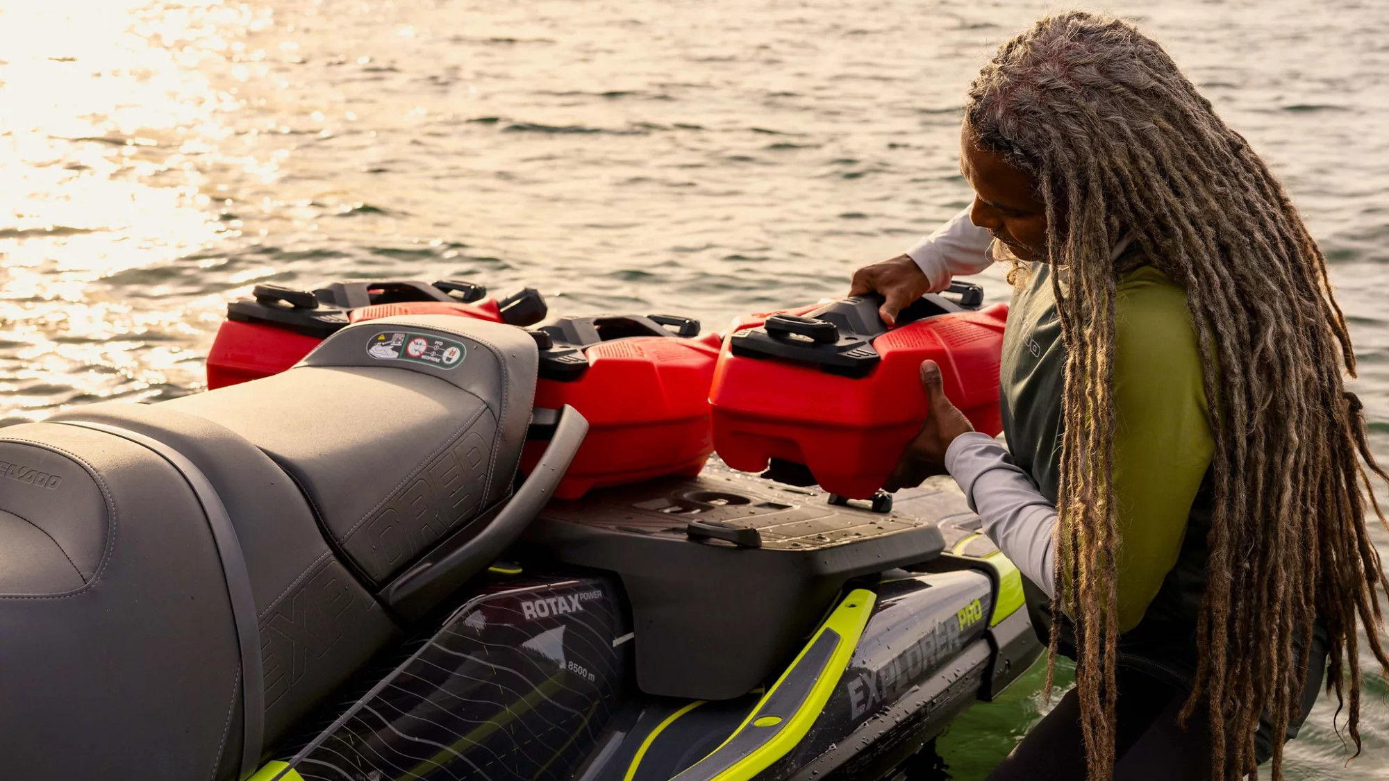 Person attaching a LinQ fuel caddy to a Sea-Doo Explorer Pro