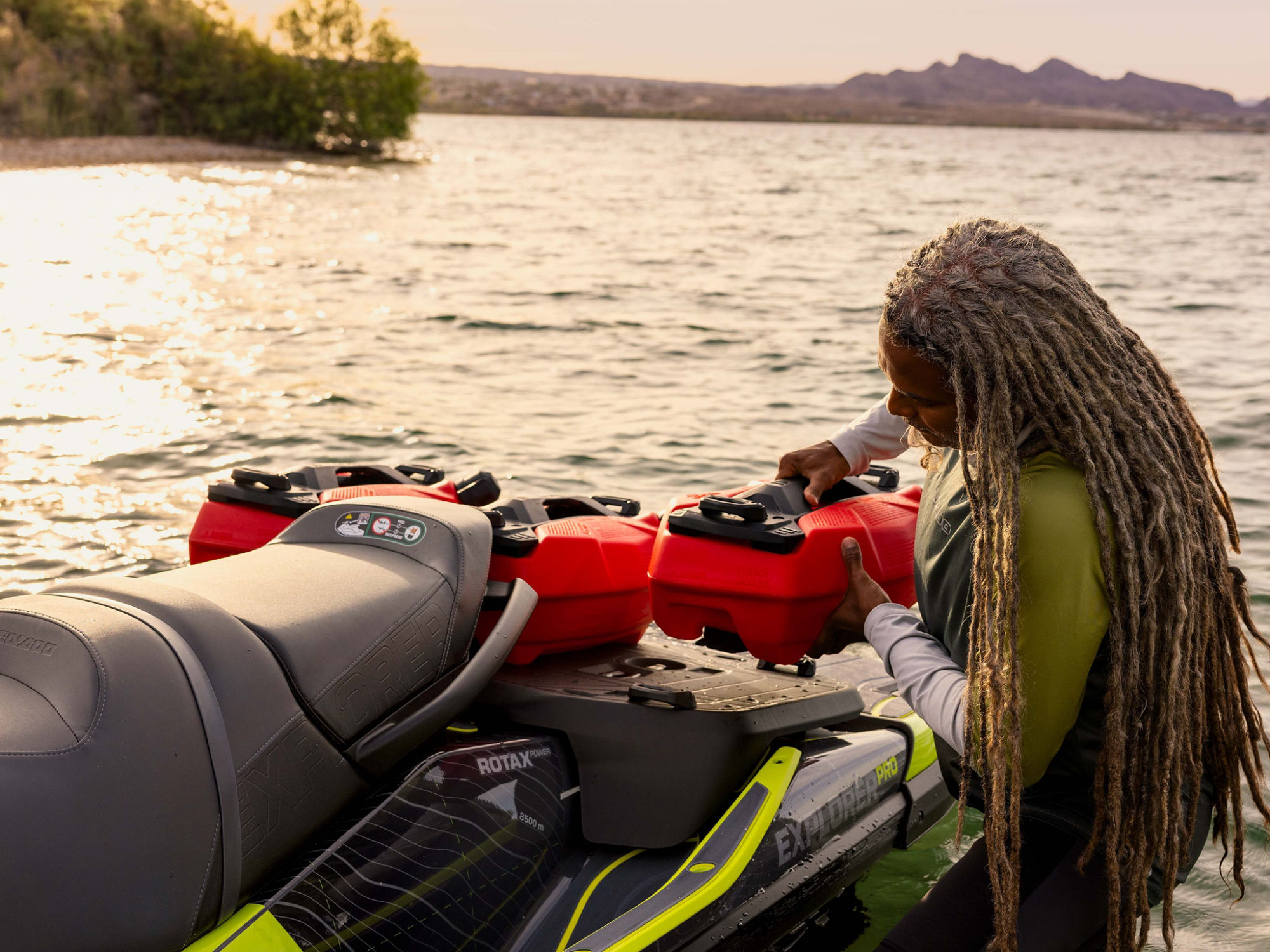 Person attaching a LinQ fuel caddy to a Sea-Doo Explorer Pro