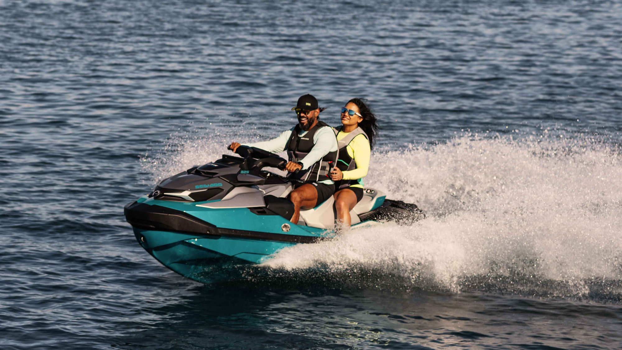 Couple riding around on a 2025 Sea-Doo GTX Limited personal watercraft