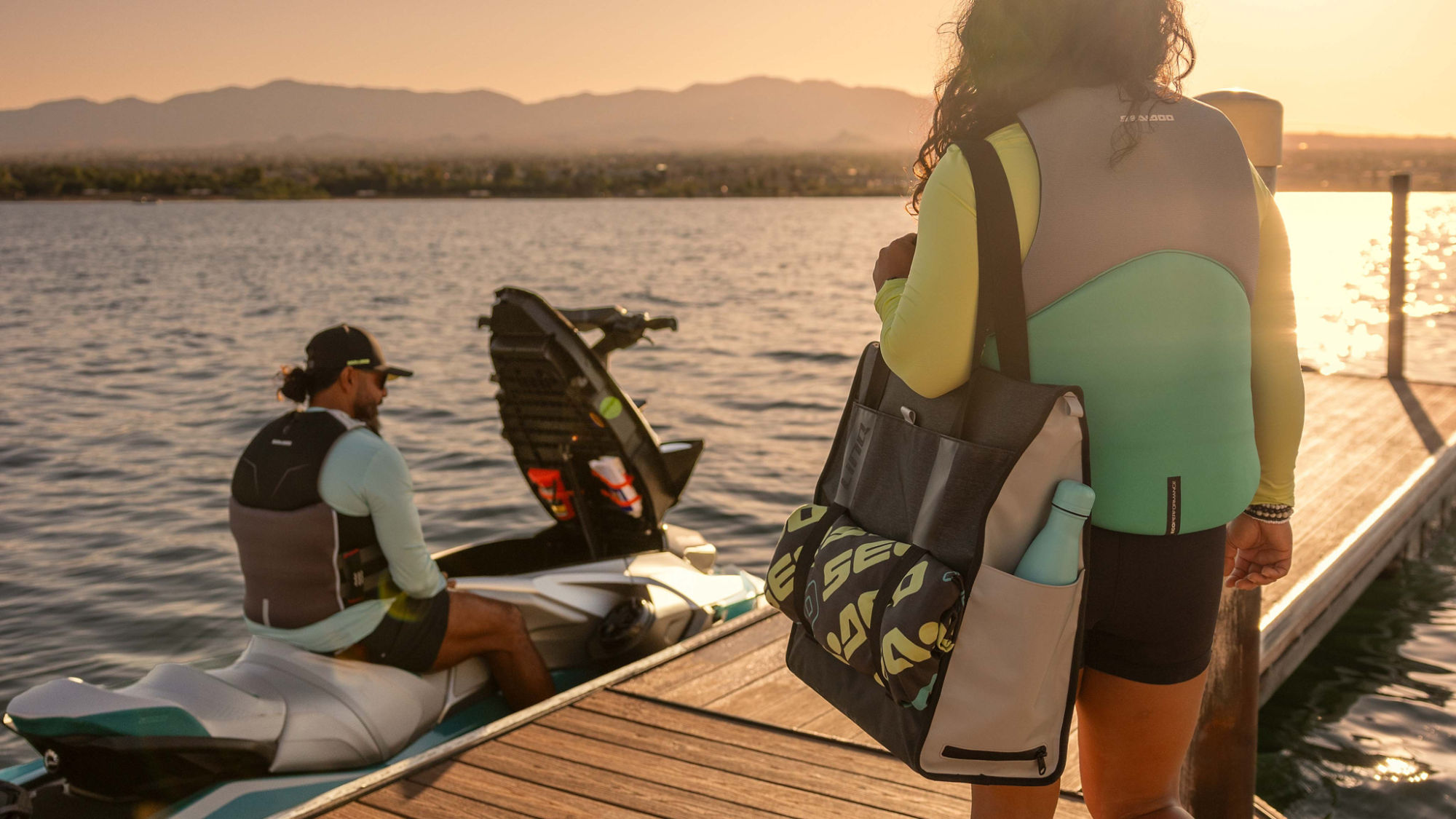 Man and woman wearing a Sea-Doo PFD life jackets