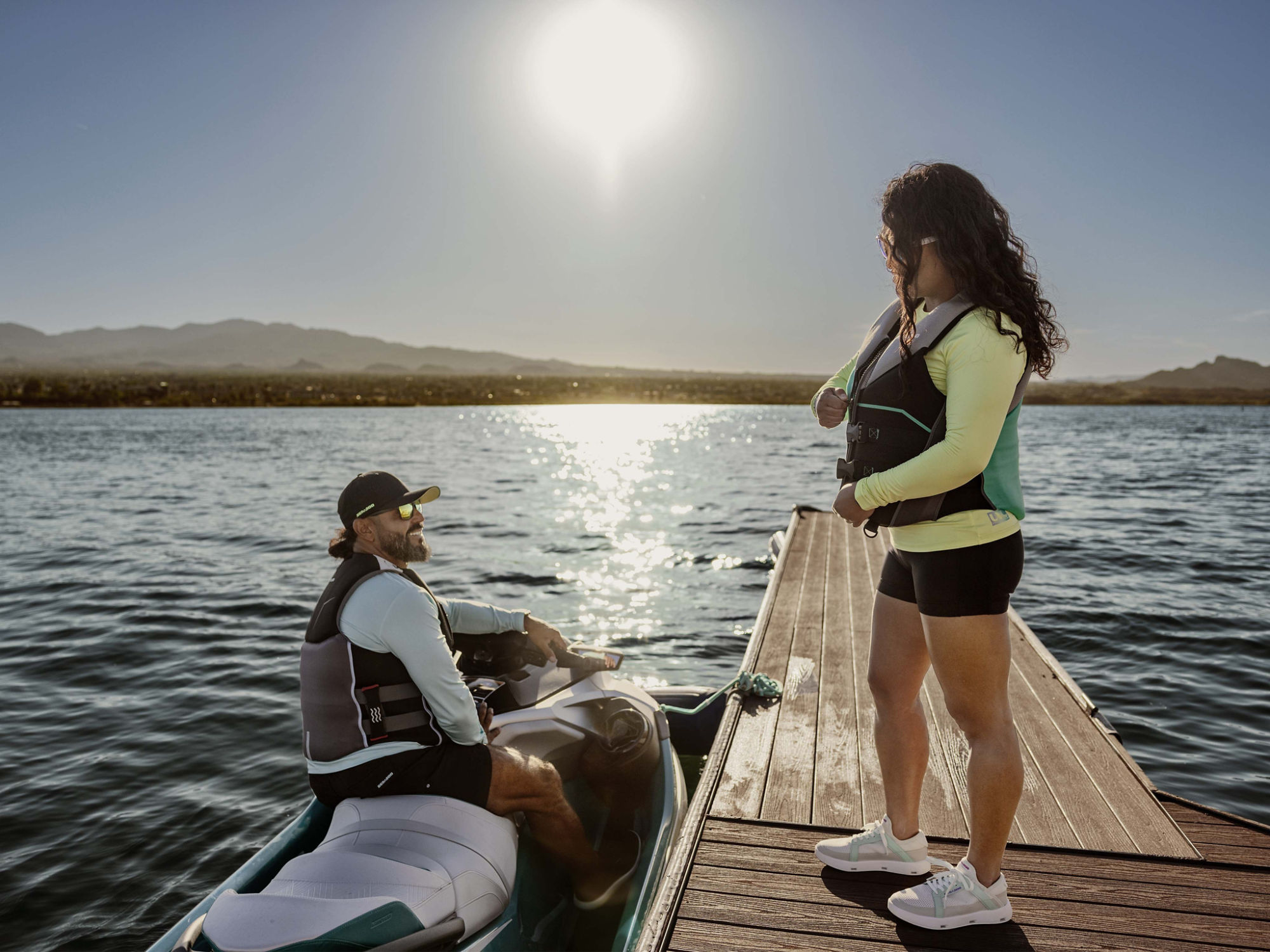 Women zipping up a Sea-Doo PFD