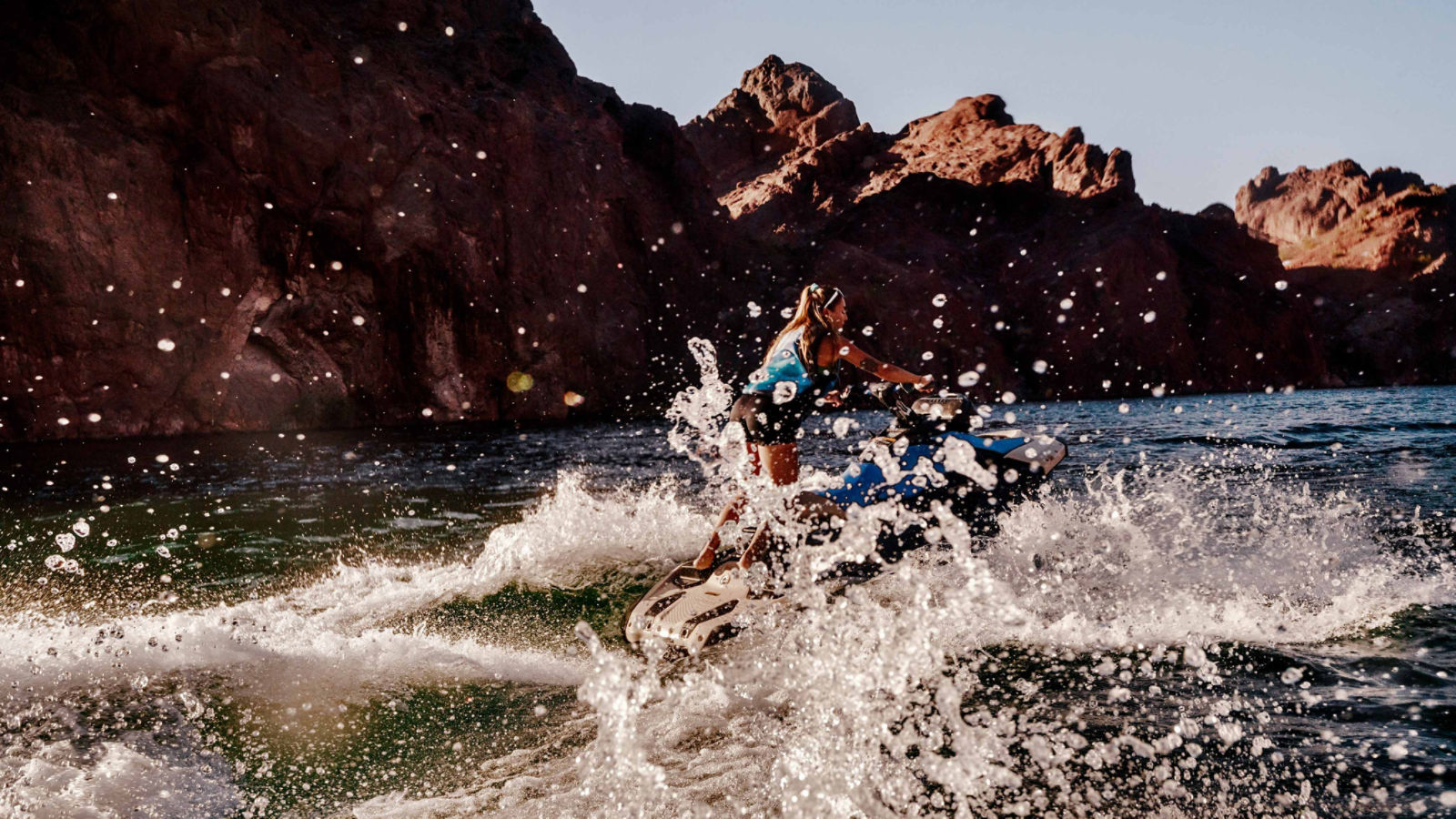 Woman pulling off a trick on a 2025 Sea-Doo Spark Trixx personal watercraft