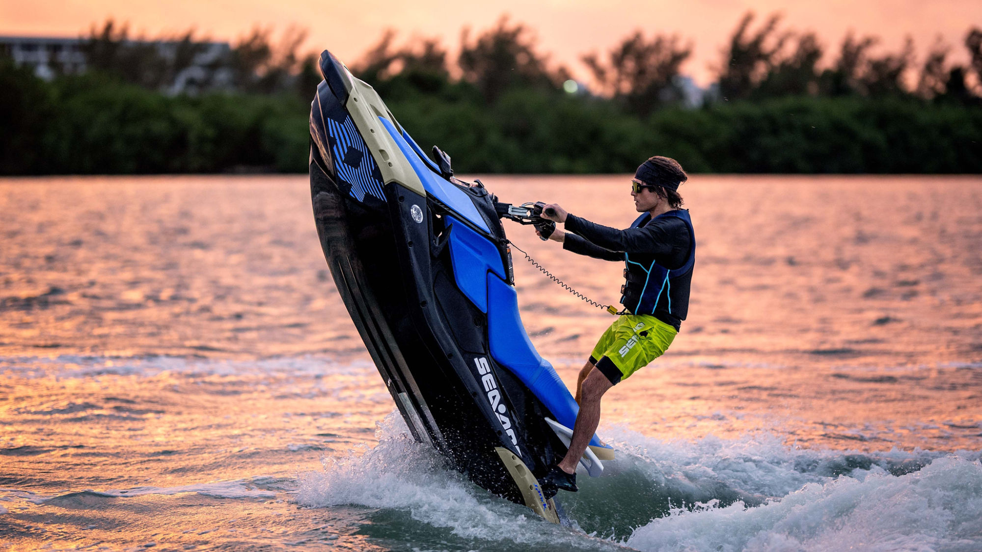 A man pulling off a trick on his 2025 Sea-Doo Spark Trixx personal watercraft 