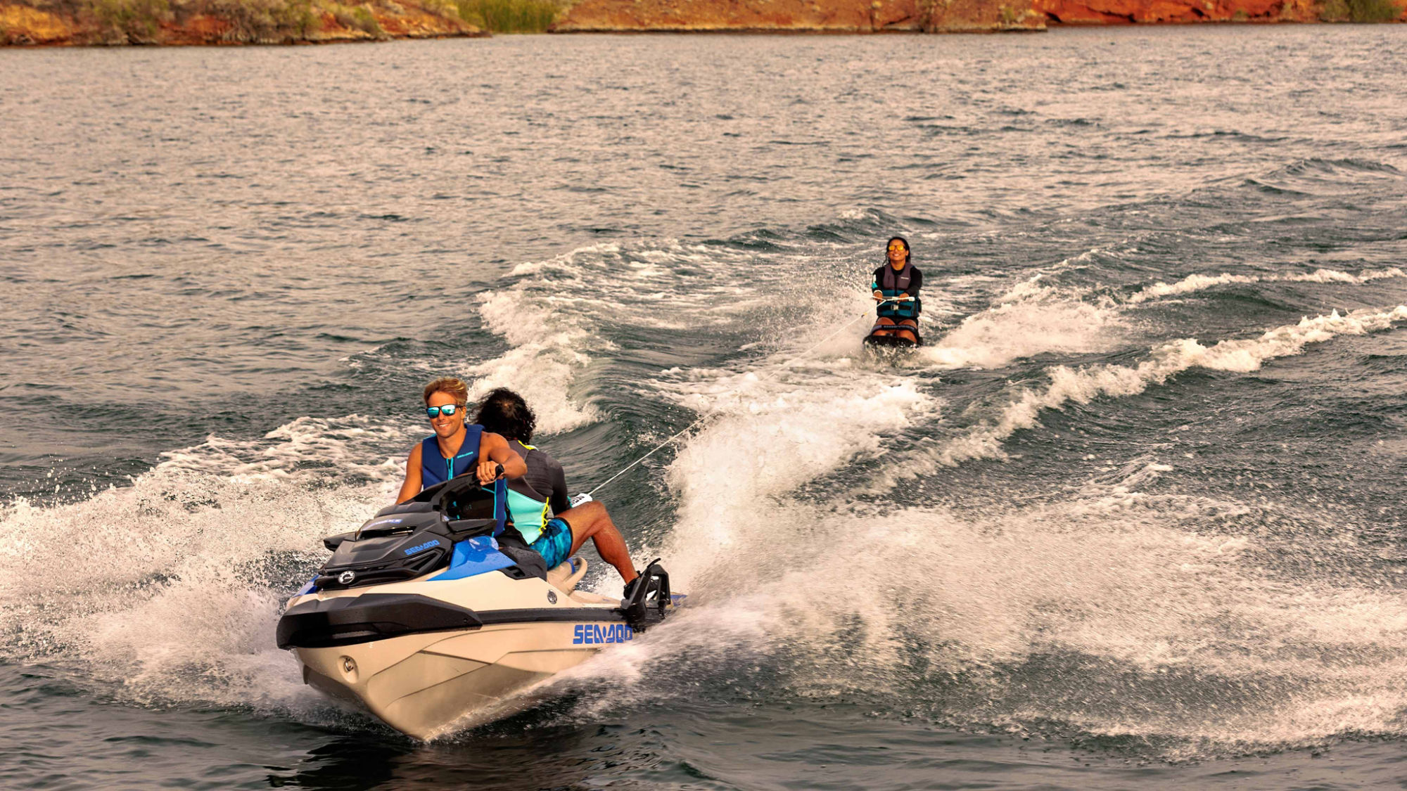 Woman towing a wakeboarder behind the Sea-Doo Wake Pro