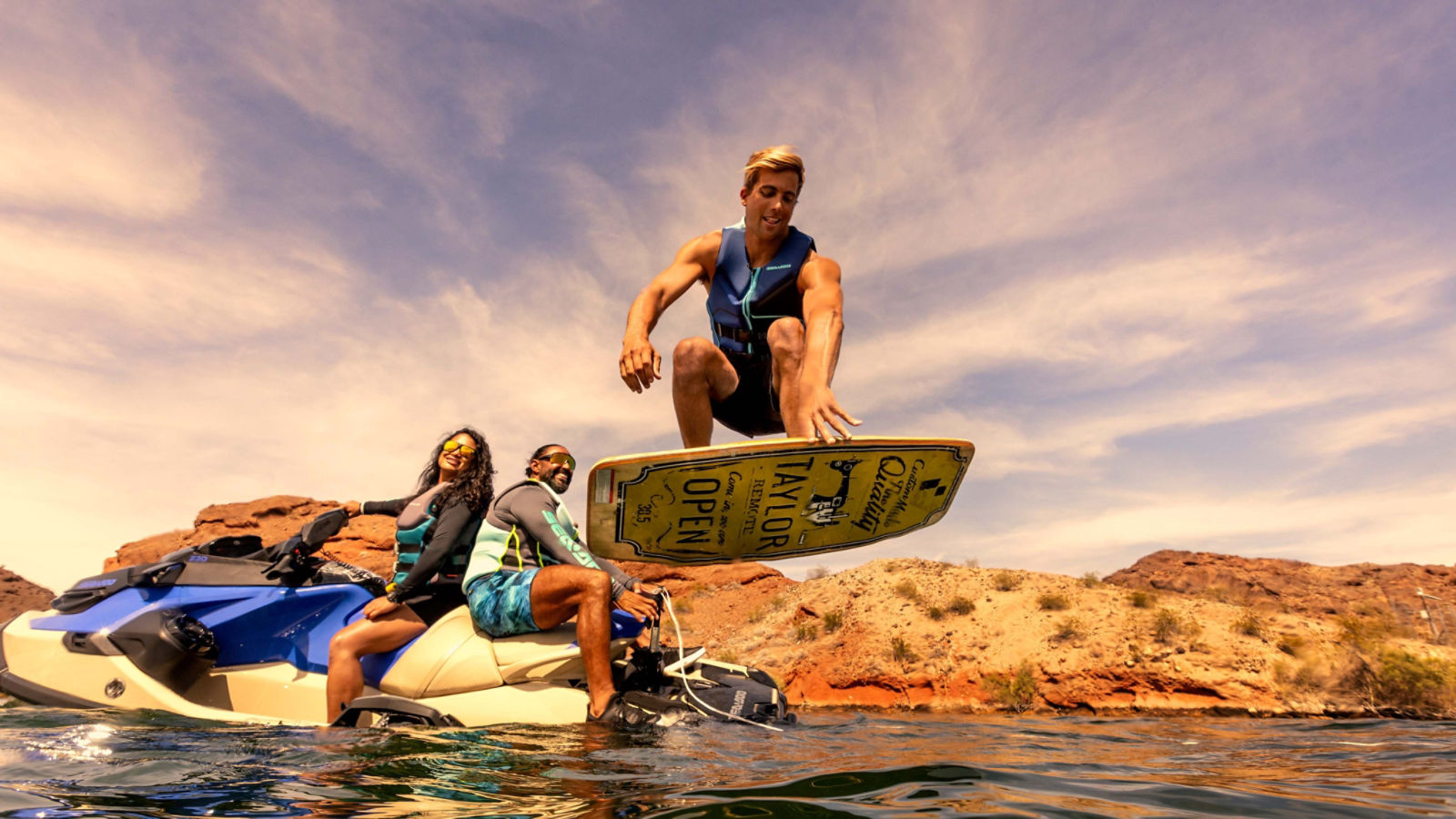 Man jumping on a wake board tied to the back of a 2024 Wake Pro 