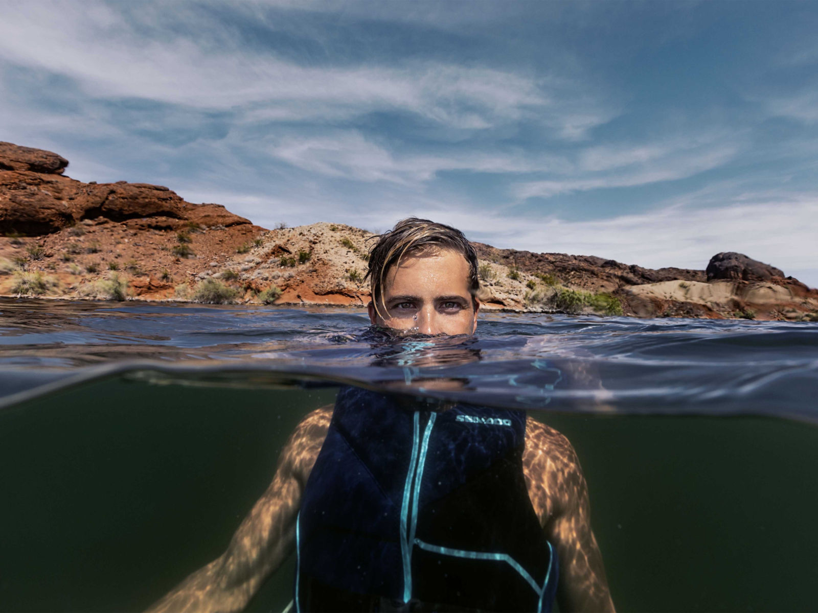 A man in the water wearing a Sea-Doo PFD