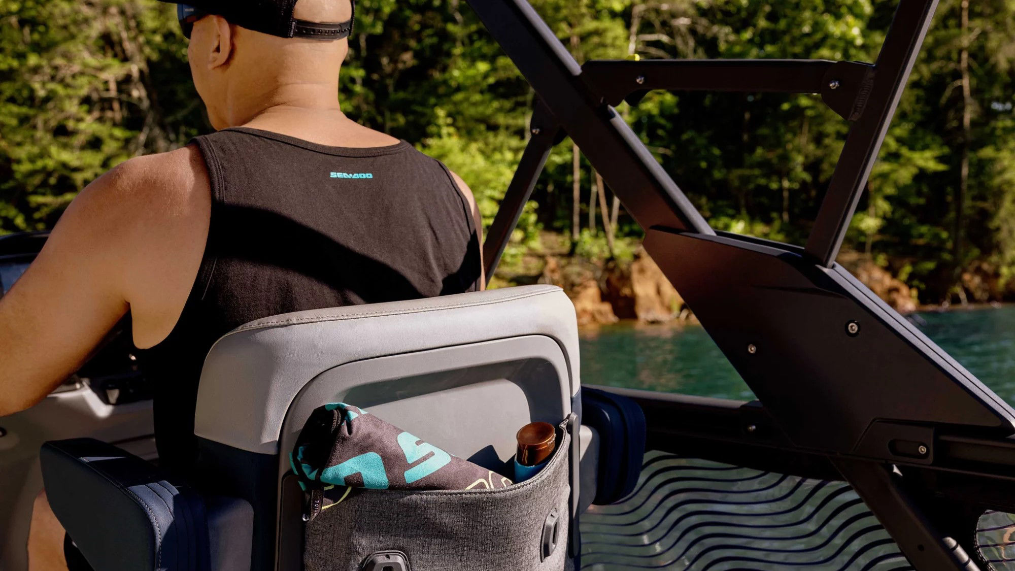 Man walking holding a Sea-Doo switch Limited seat