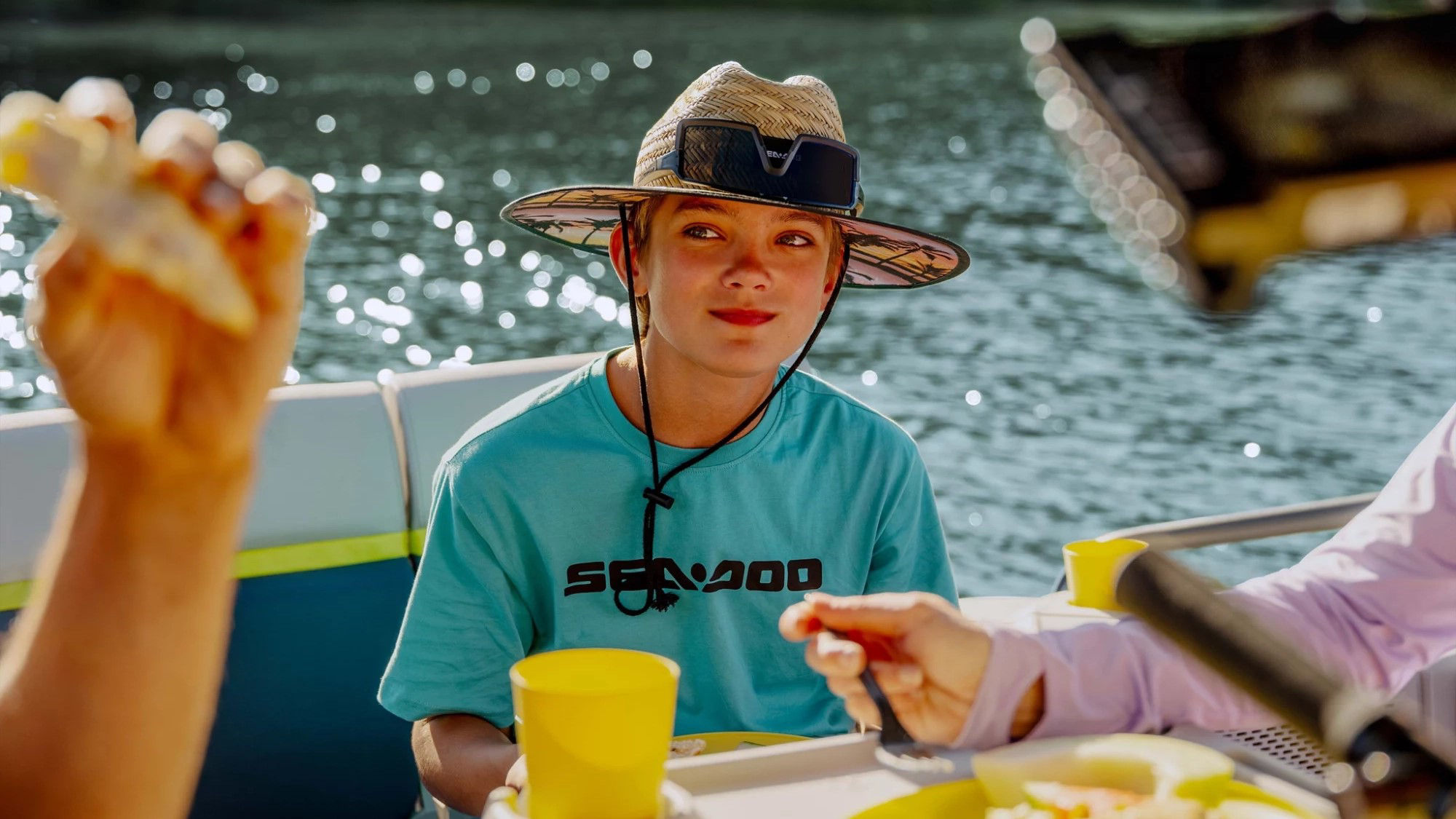Women zipping up her kid Sea-Doo PFD
