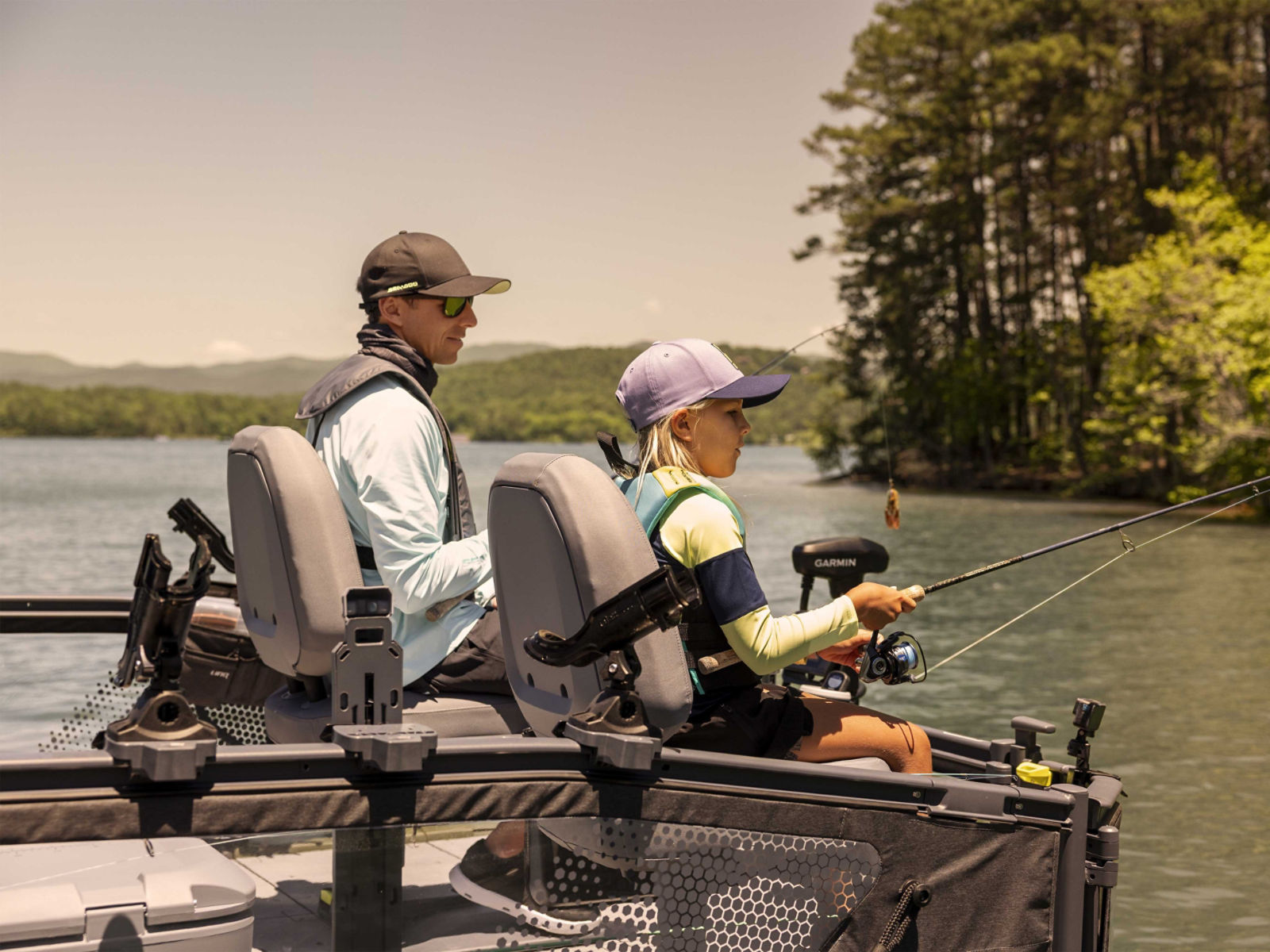 Father and daughter fishing from the 2025 Sea-Doo Switch Fish pontoon boat