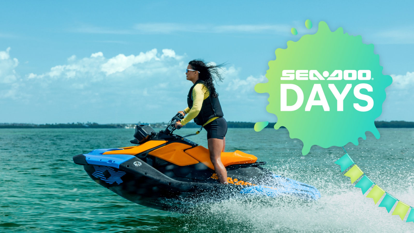 A woman riding a Sea-Doo Spark Trixx personal watercraft in a standing position