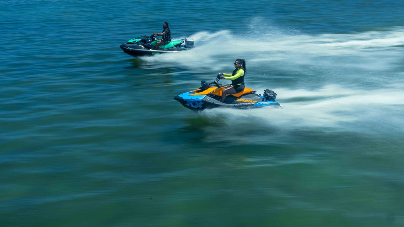 A woman and a man riding a Sea-Doo personal watercraft