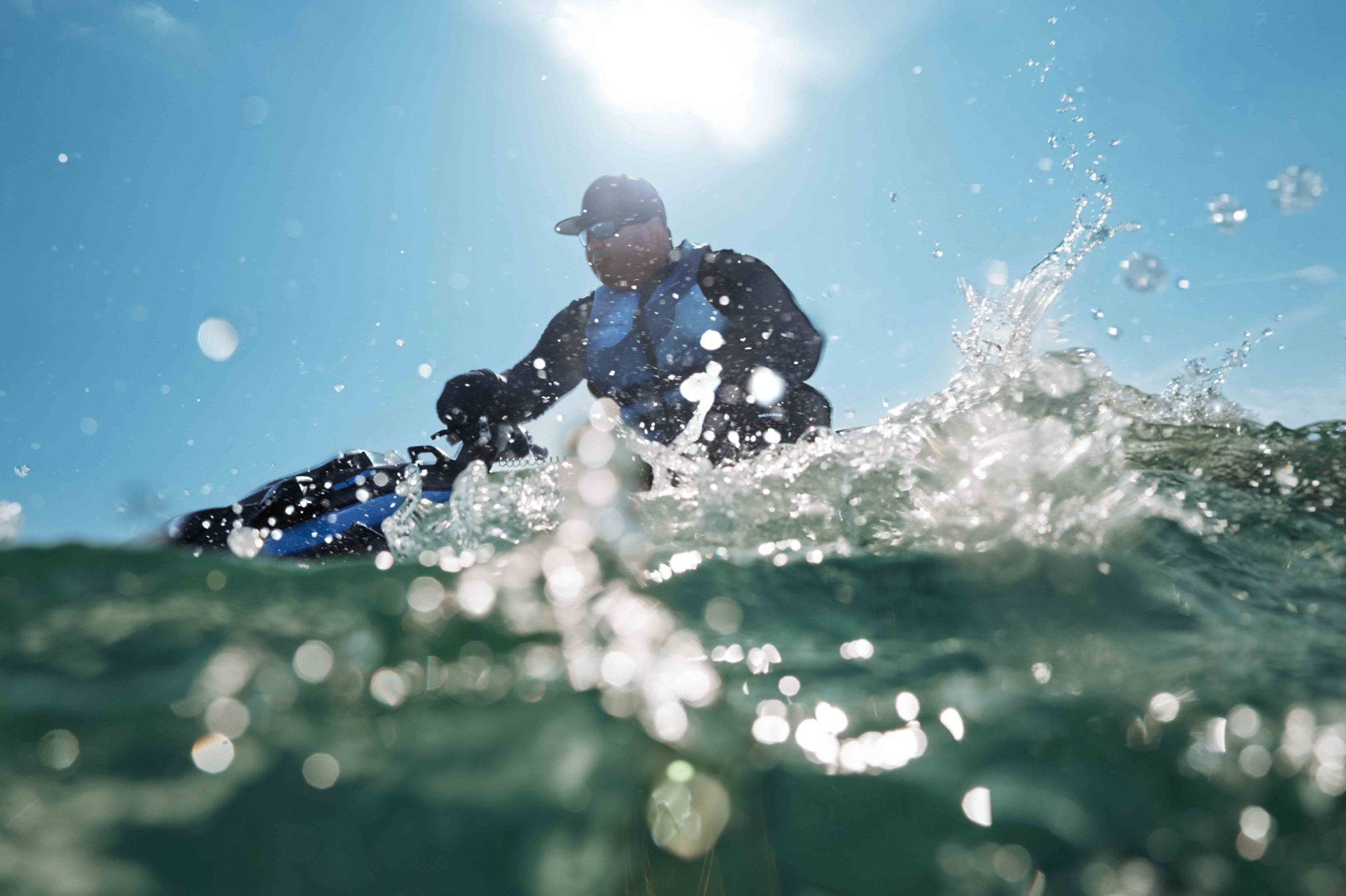 Men jumping a wave with a 2024 Sea-Doo RXP-X equipped with a LinQ fuel caddy