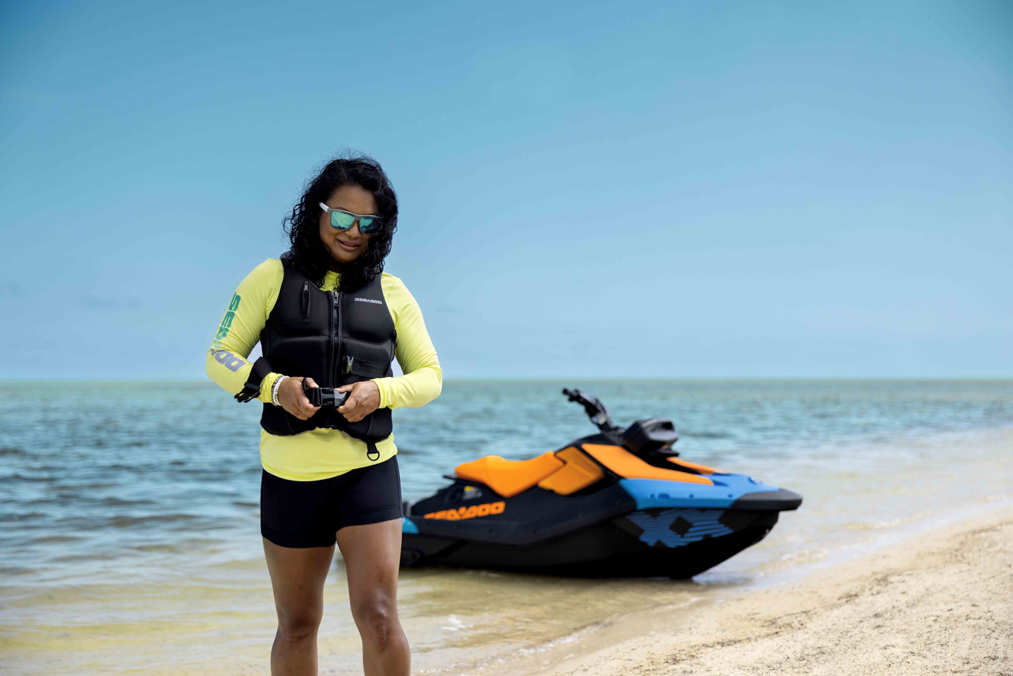Women zipping up a Sea-Doo PFD