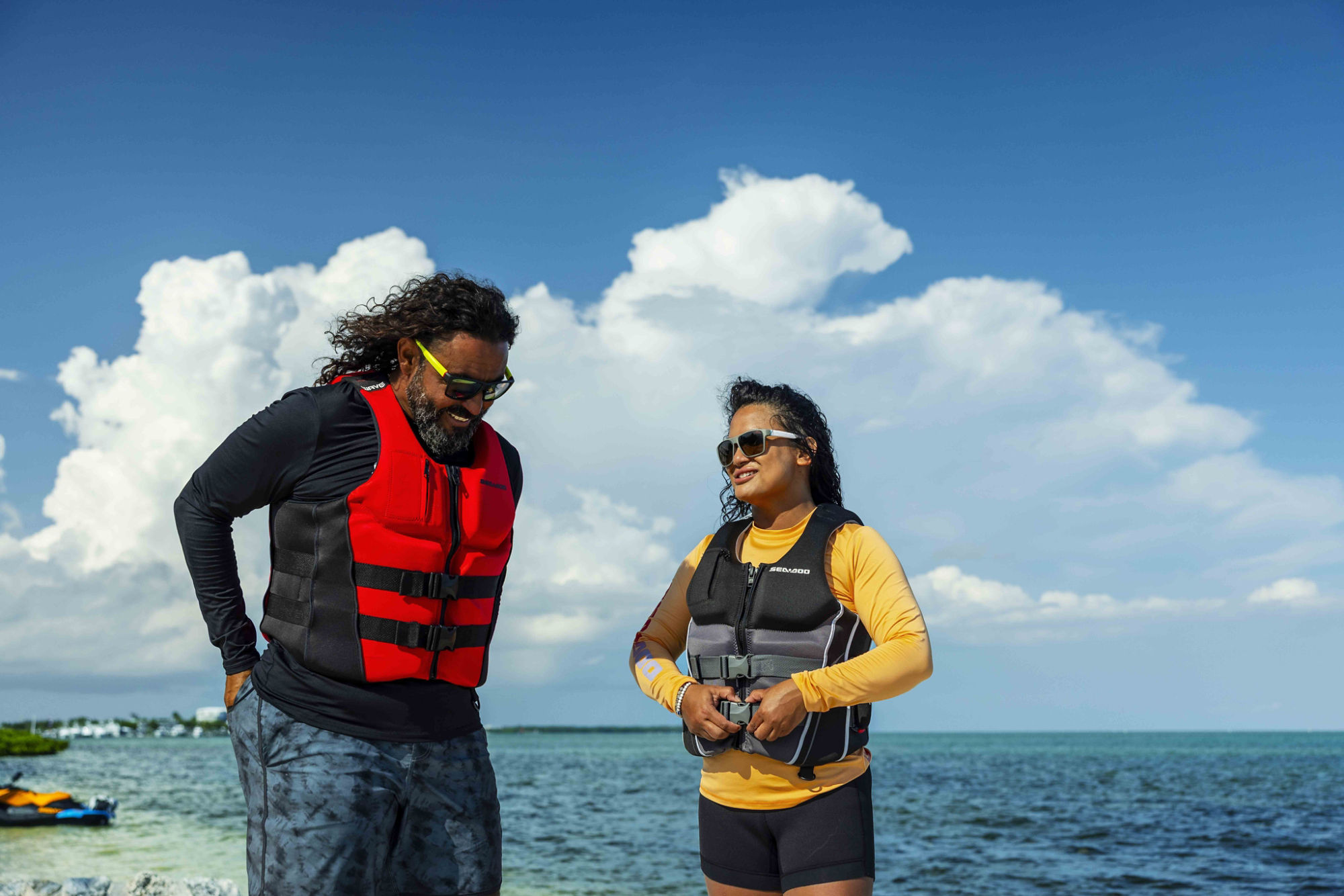 Women zipping up a Sea-Doo PFD