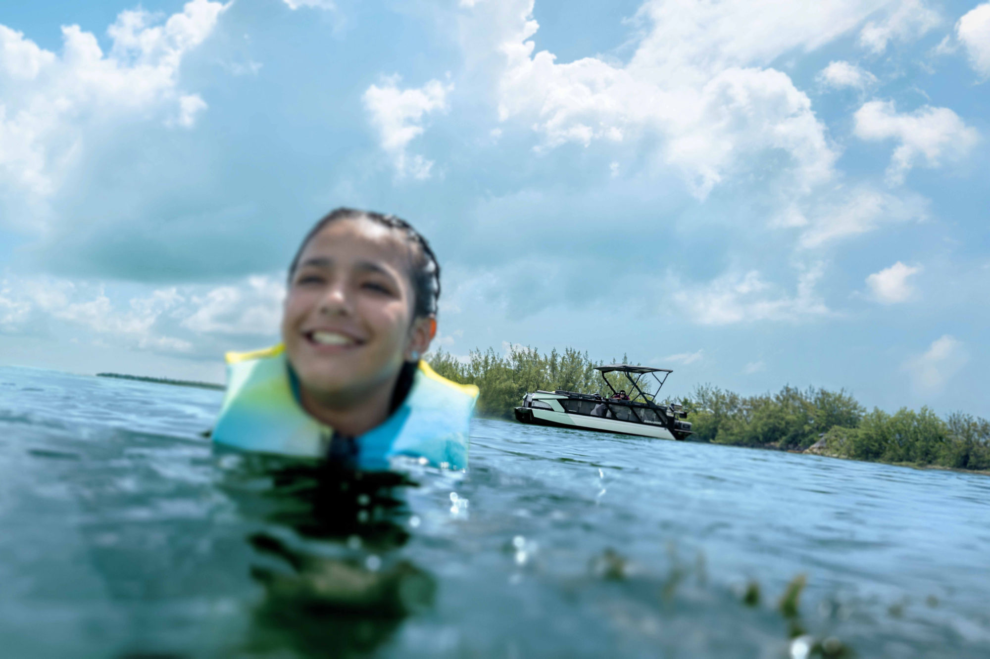 Women zipping up her kid Sea-Doo PFD