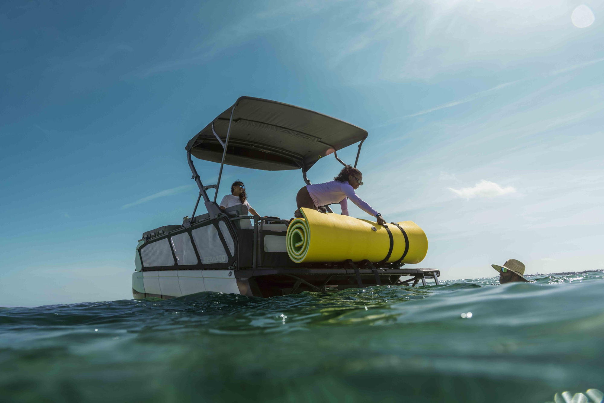 Men attaching a LinQ cooler on a Sea-Doo Switch pontoon