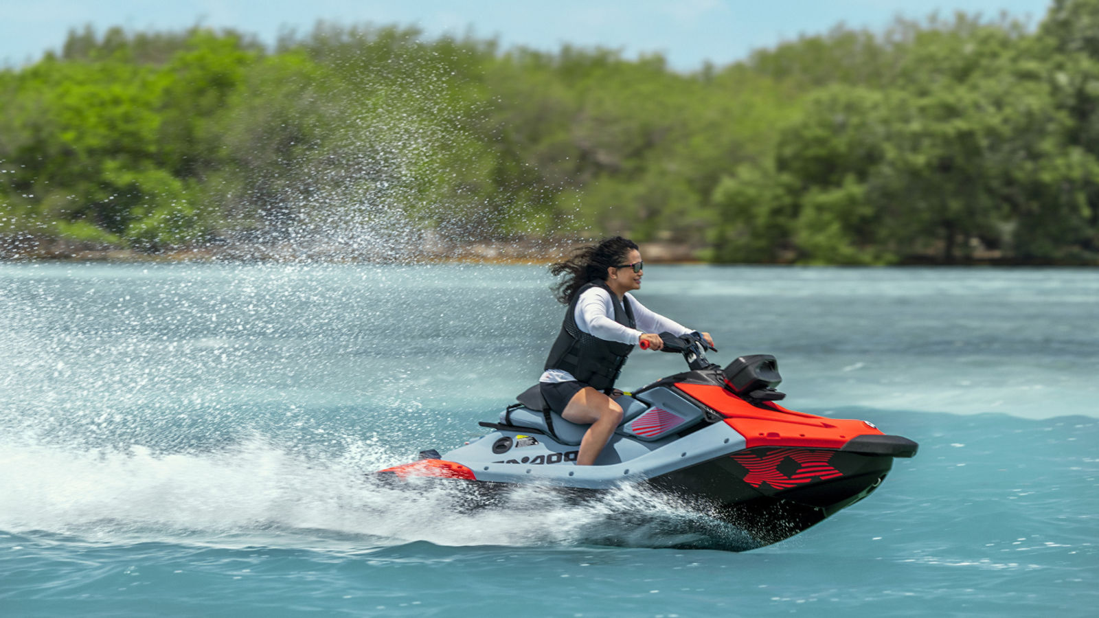 A woman riding a 2027 Sea-Doo Spark X Trixx