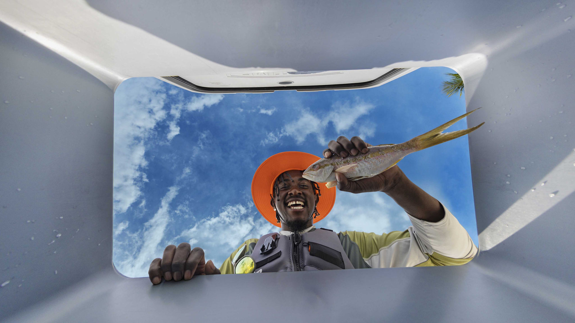 Men adding a freshly catch fish in a LinQ cooler