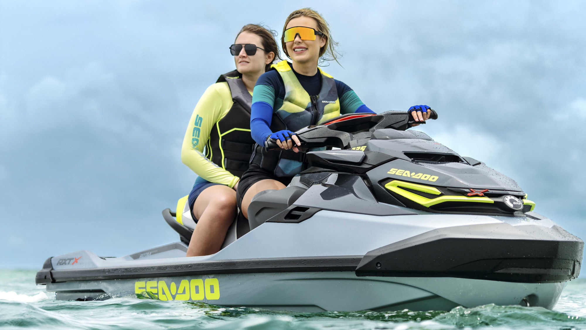 Two women on a 2024 RXT-X wearing Sea-Doo performance apparel 