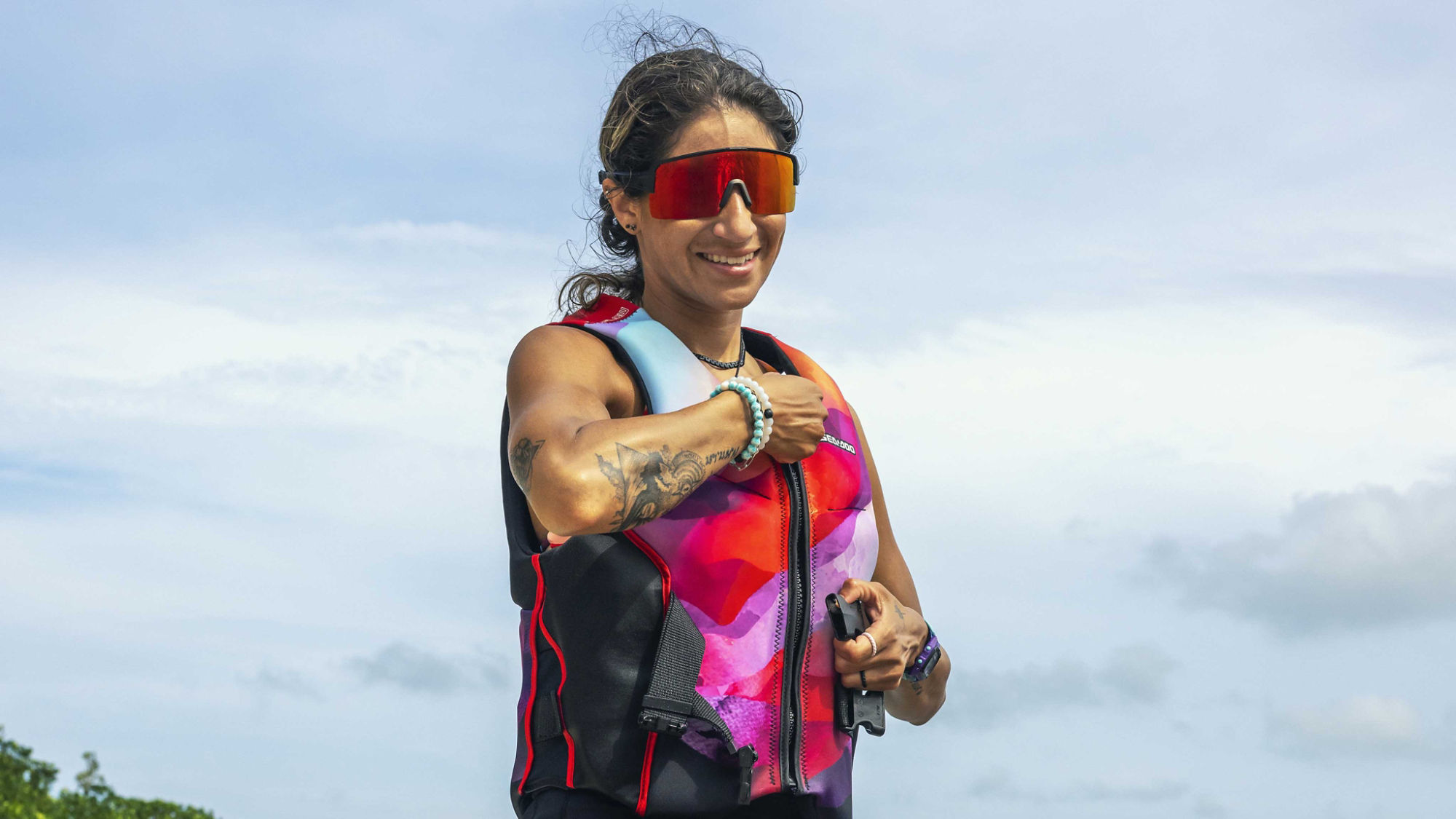 Women zipping up a Sea-Doo PFD