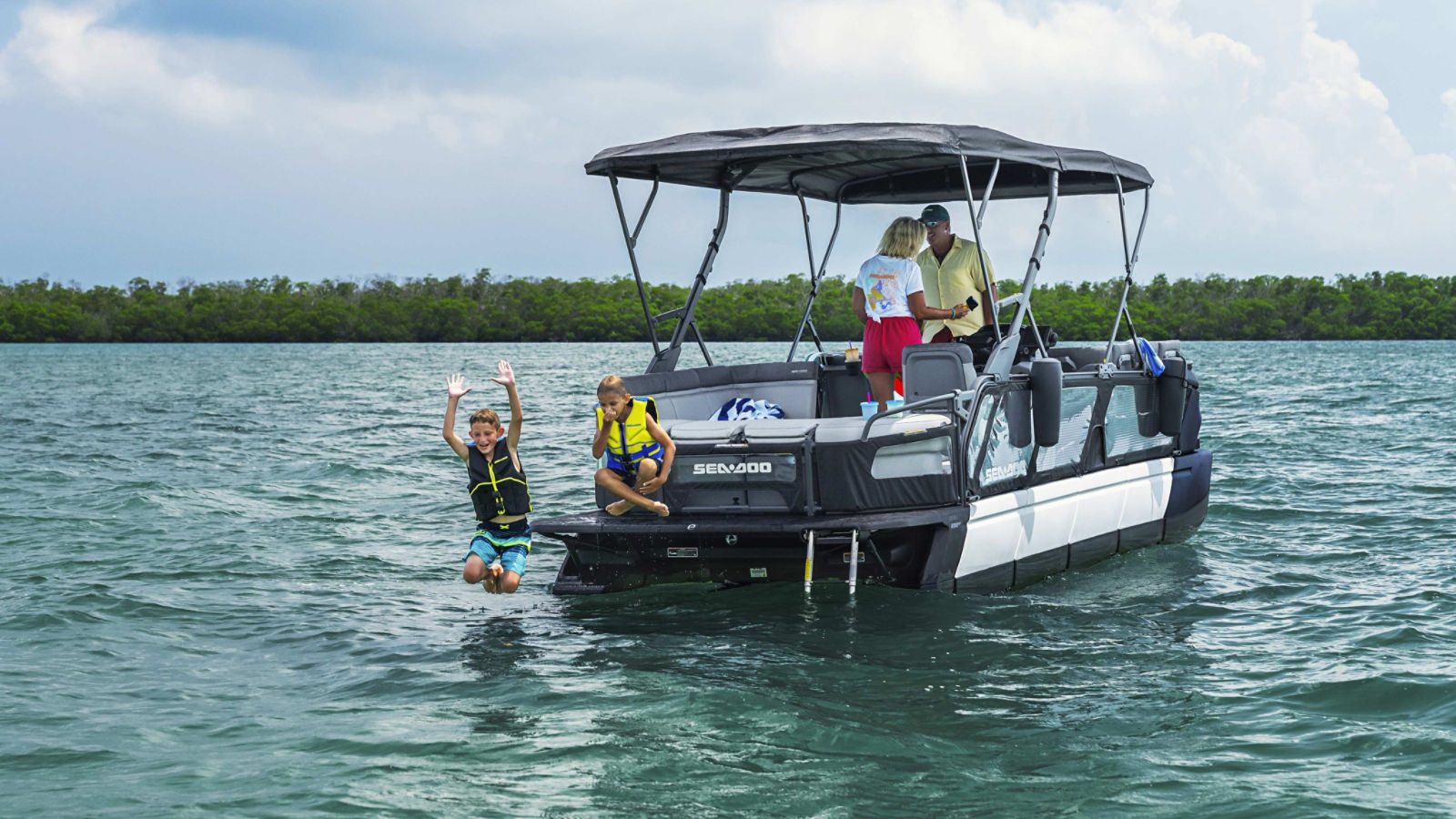 Children jumping off the back of a Sea-Doo Switch