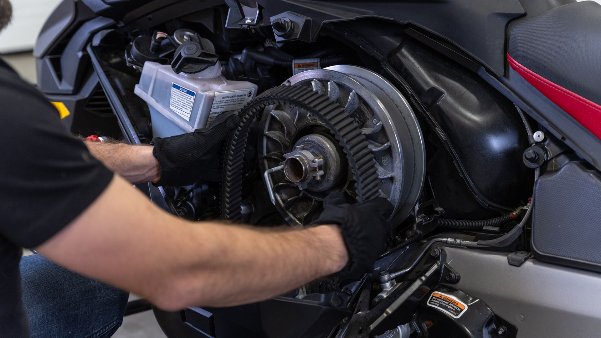 Man changing CVT belt on a Ski-Doo Freeride