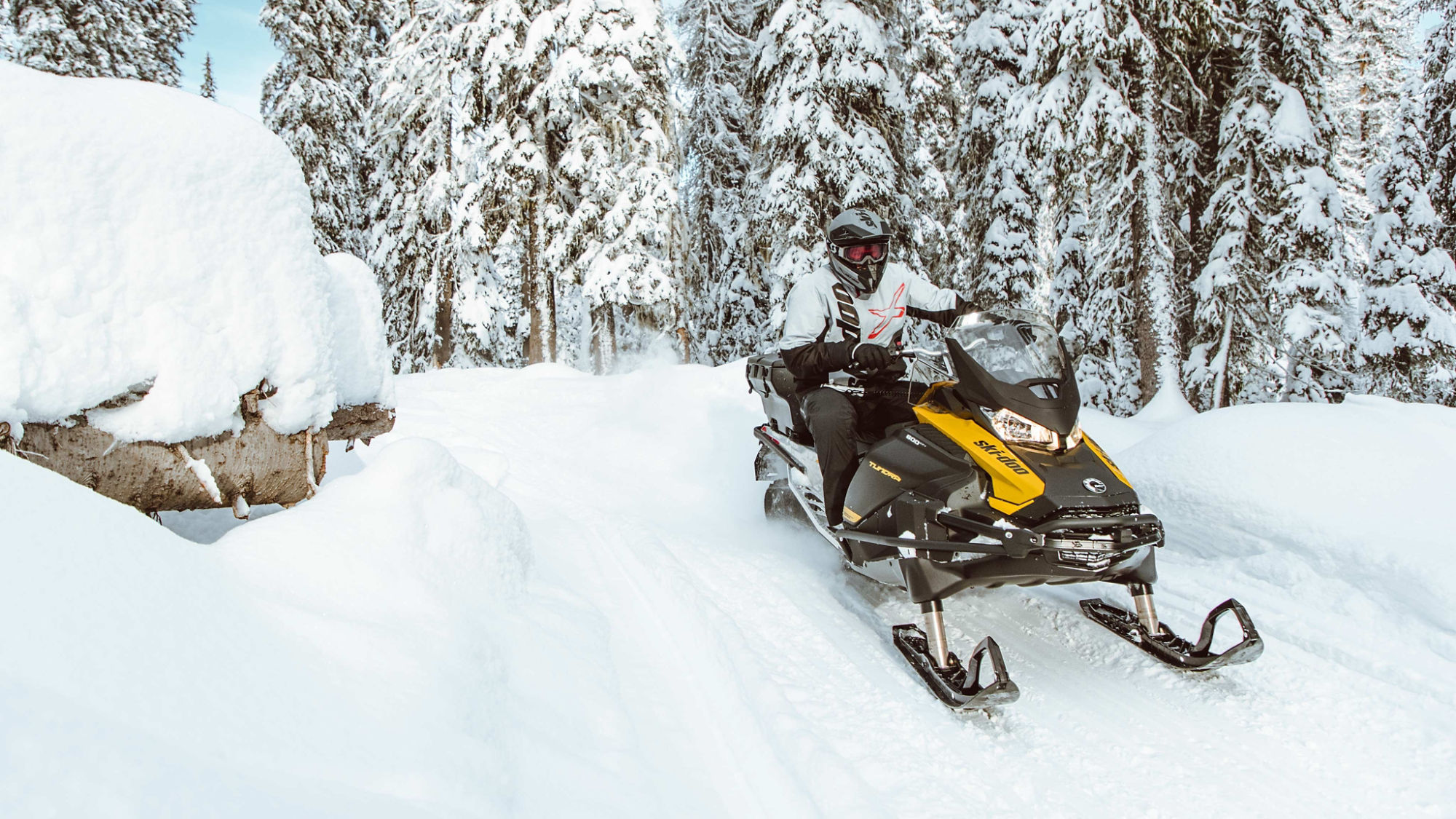 Man driving a Ski-Doo Tundra snowmobile in trail