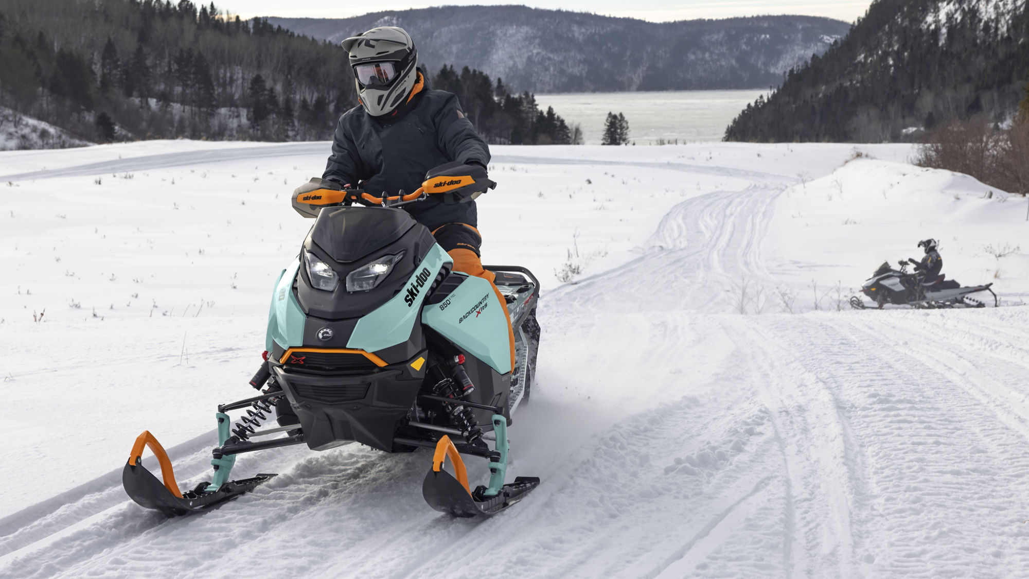 Man riding a Ski-Doo Backcountry in trail