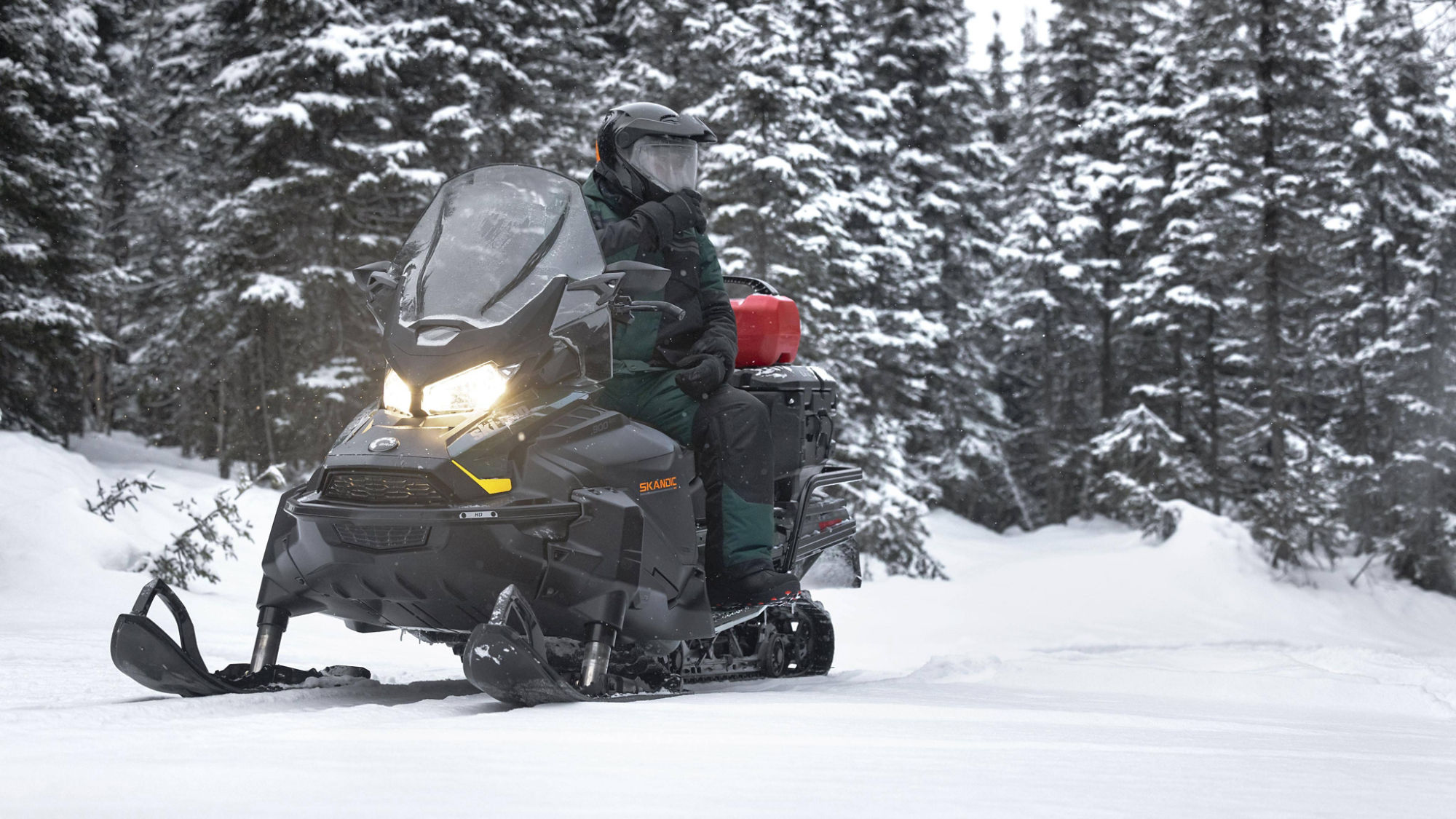 Man sitting on a Skandic SE snowmobile